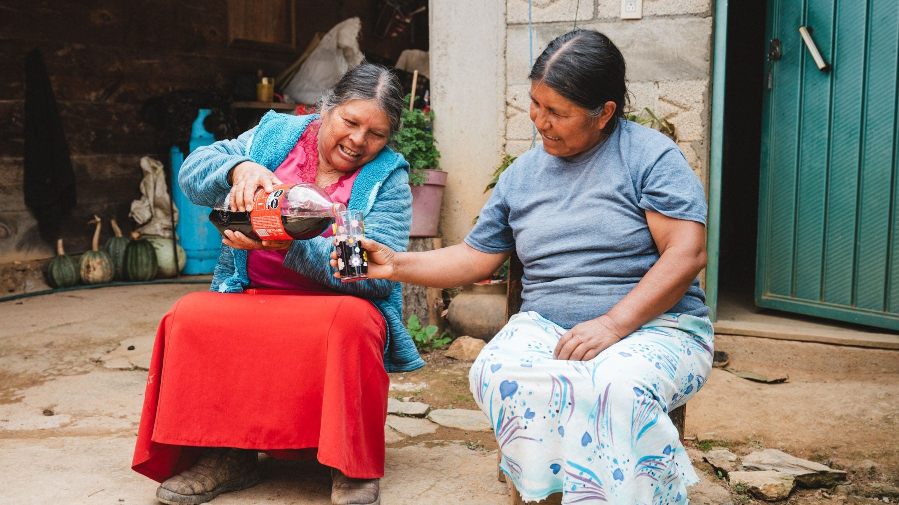 Two indigenous Mexican woman sharing a coca cola