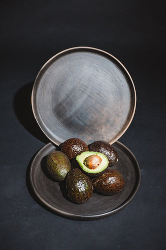 handmade barro negro plates from oaxaca with avocados