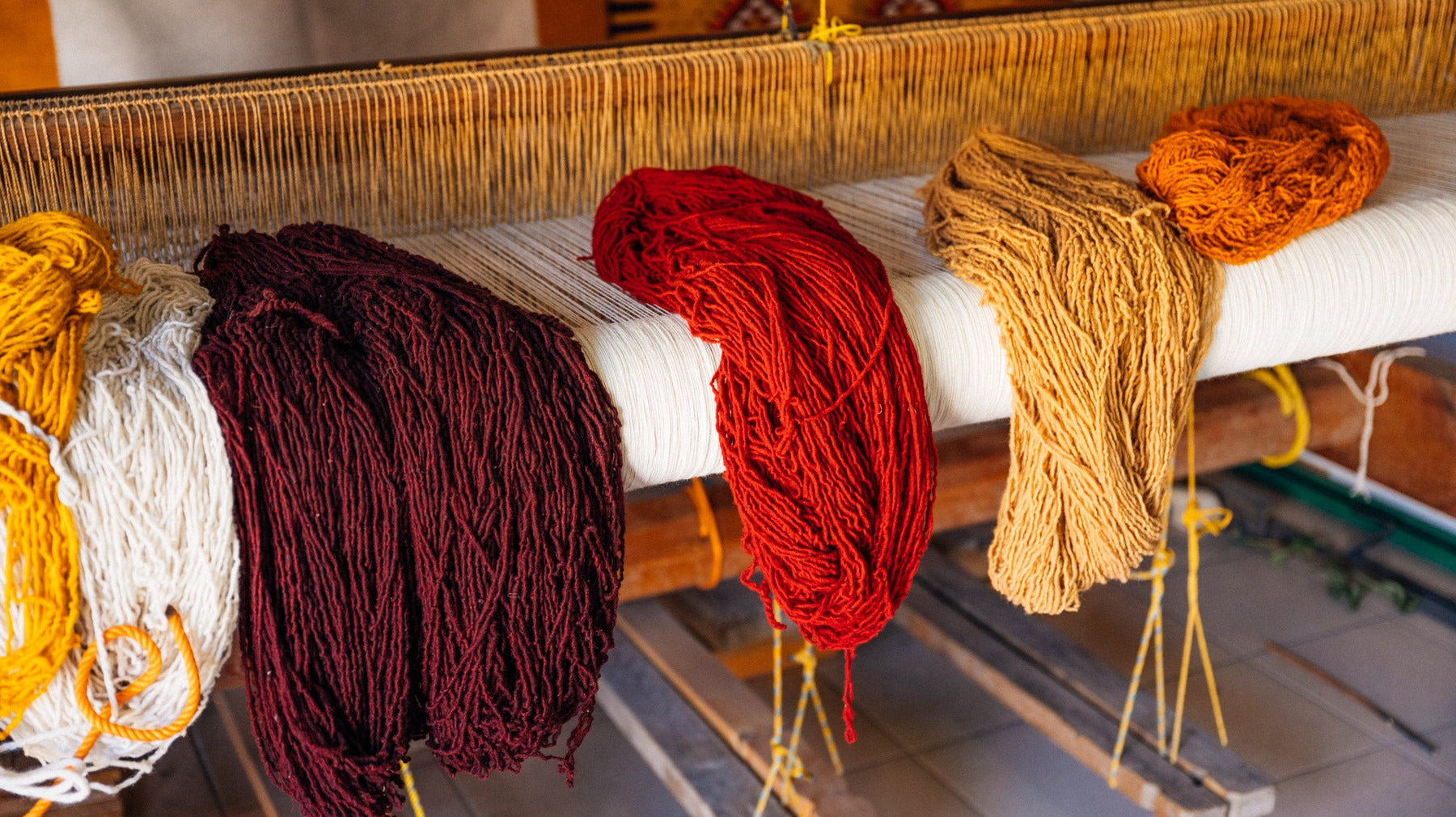 Spools of freshly dyed natural wool sitting on the loom in Teotitlan Del Valle
