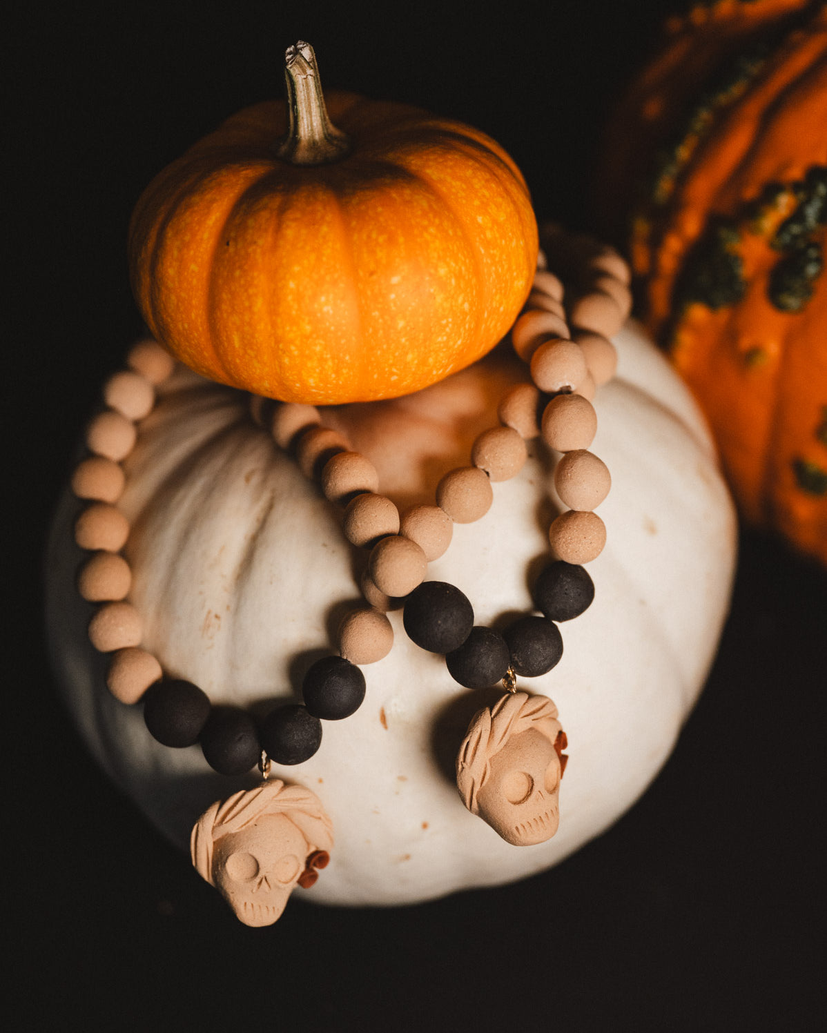 Decorative necklace with pumpkins on a dark background