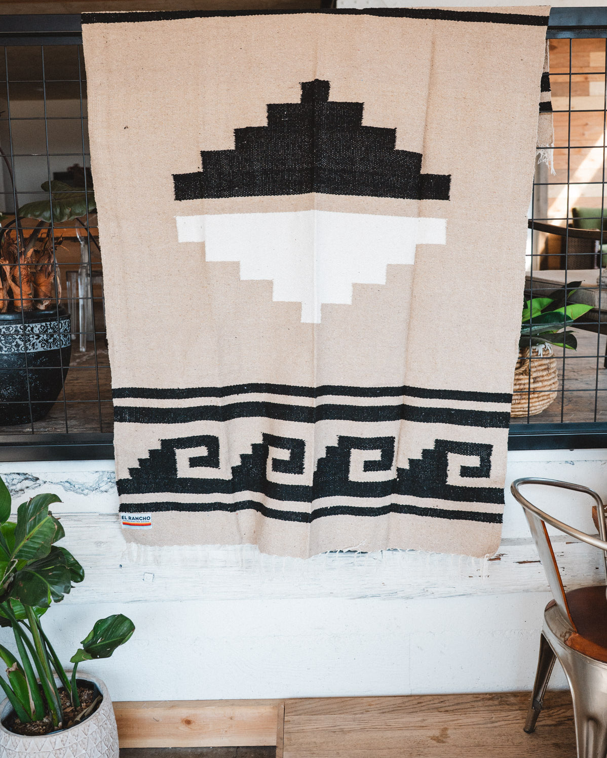 Handwoven Mexican Blanket beige Mixteca Greca  pattern in modern industrial setting