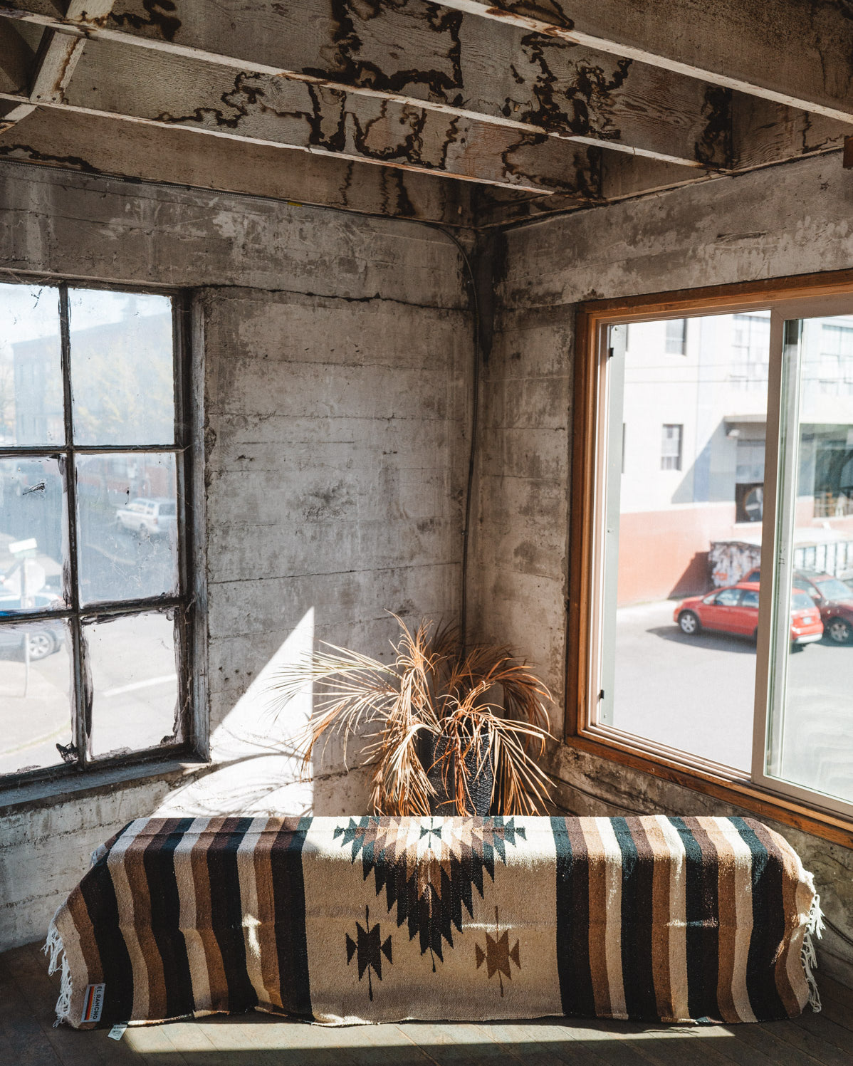 Brown beige and neutral colored handwoven Mexican blanket in urban loft setting