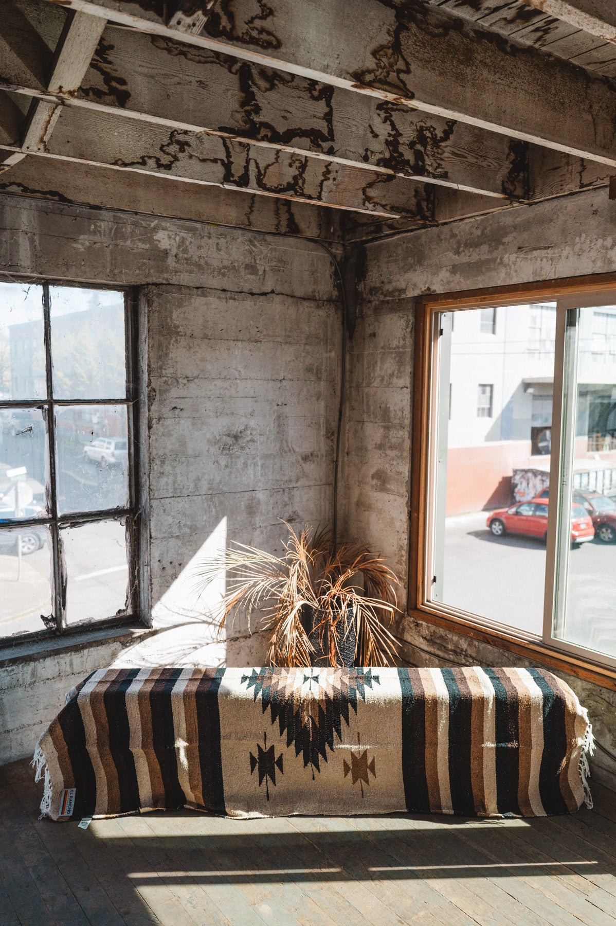 Brown beige and neutral colored handwoven Mexican blanket in urban loft setting