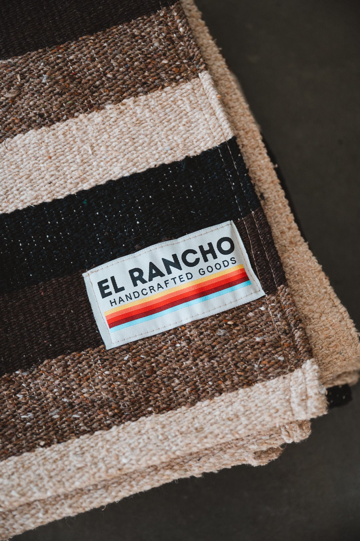 Brown handwoven mexican blanket for dogs against concrete background