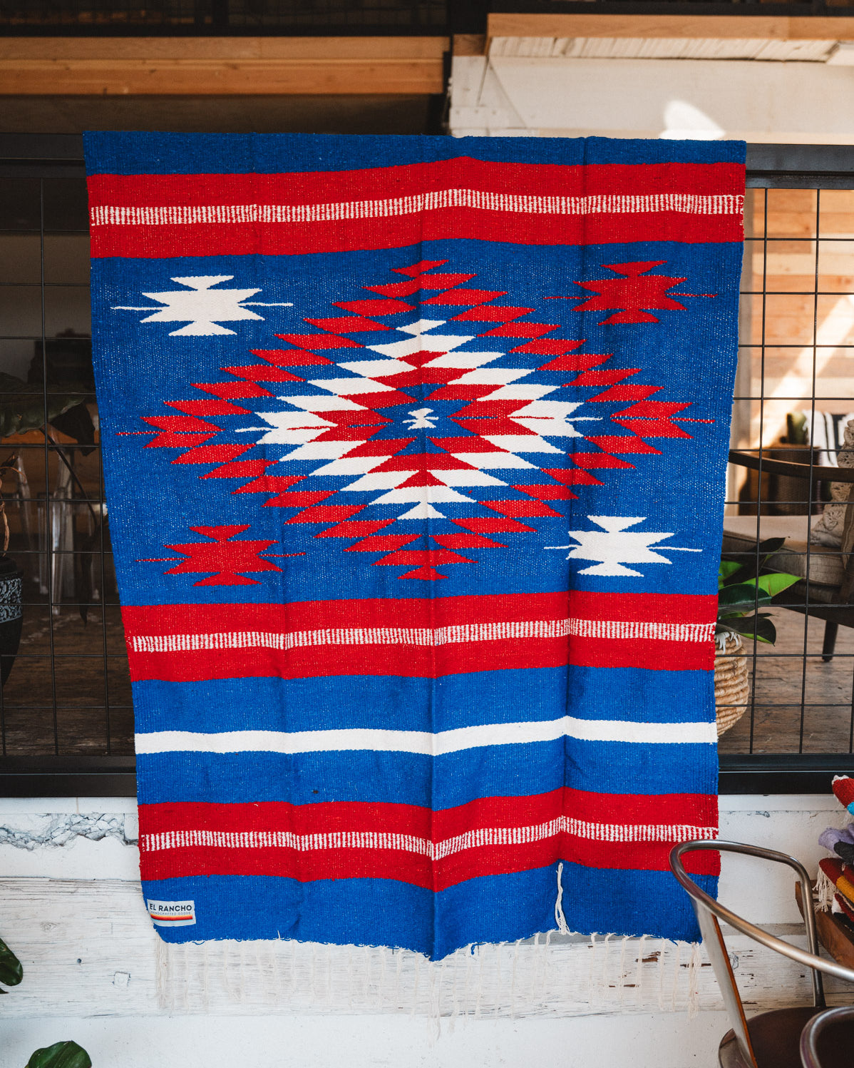 Handwoven Mexican Blanket Buffalo USA color Diamond pattern in modern industrial setting