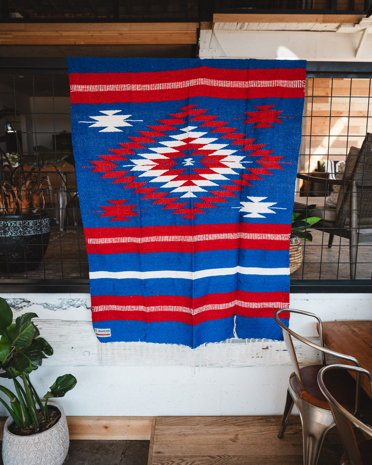 Handwoven Mexican Blanket Buffalo USA color Diamond pattern in modern industrial setting