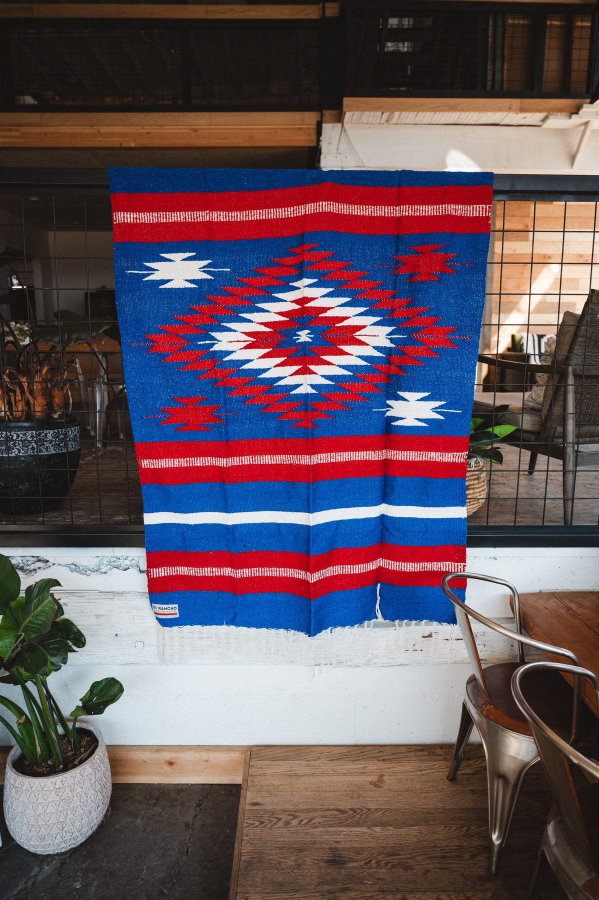 Handwoven Mexican Blanket Buffalo USA color Diamond pattern in modern industrial setting