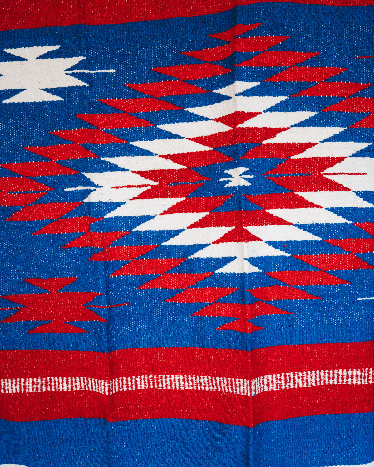 Handwoven Mexican Blanket Buffalo USA color Diamond pattern in modern industrial setting