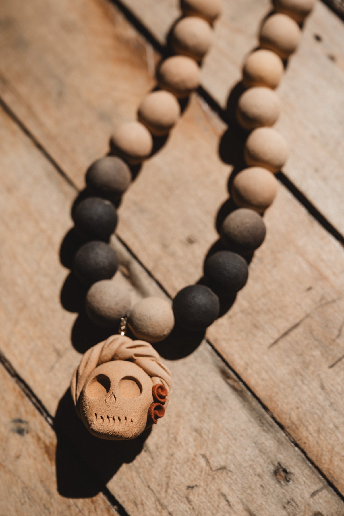 Barro negro catrina necklace on wooden background