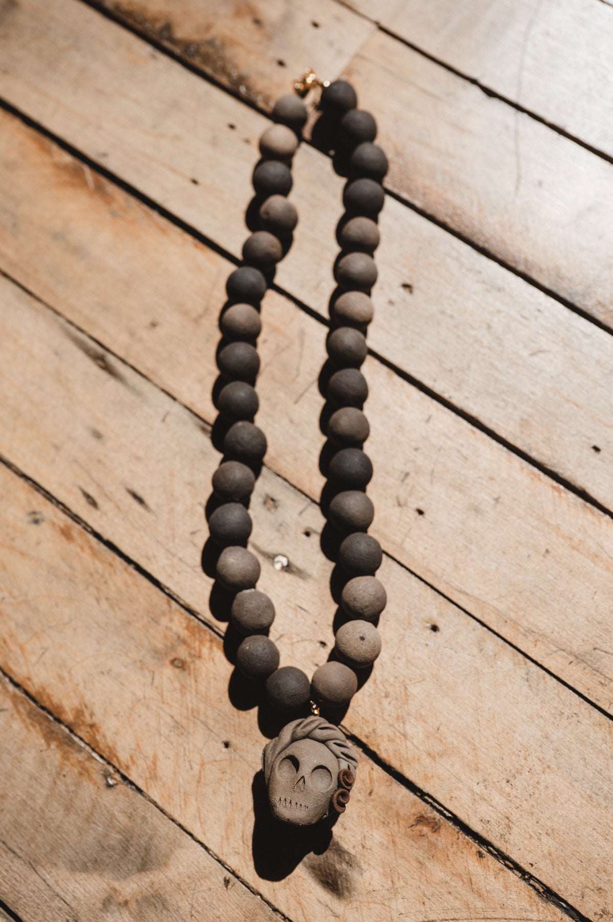 Barro negro catrina necklace on wooden background