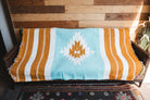 Handwoven Mexican Blanket Turquoise and gold color Diamond pattern in modern industrial setting