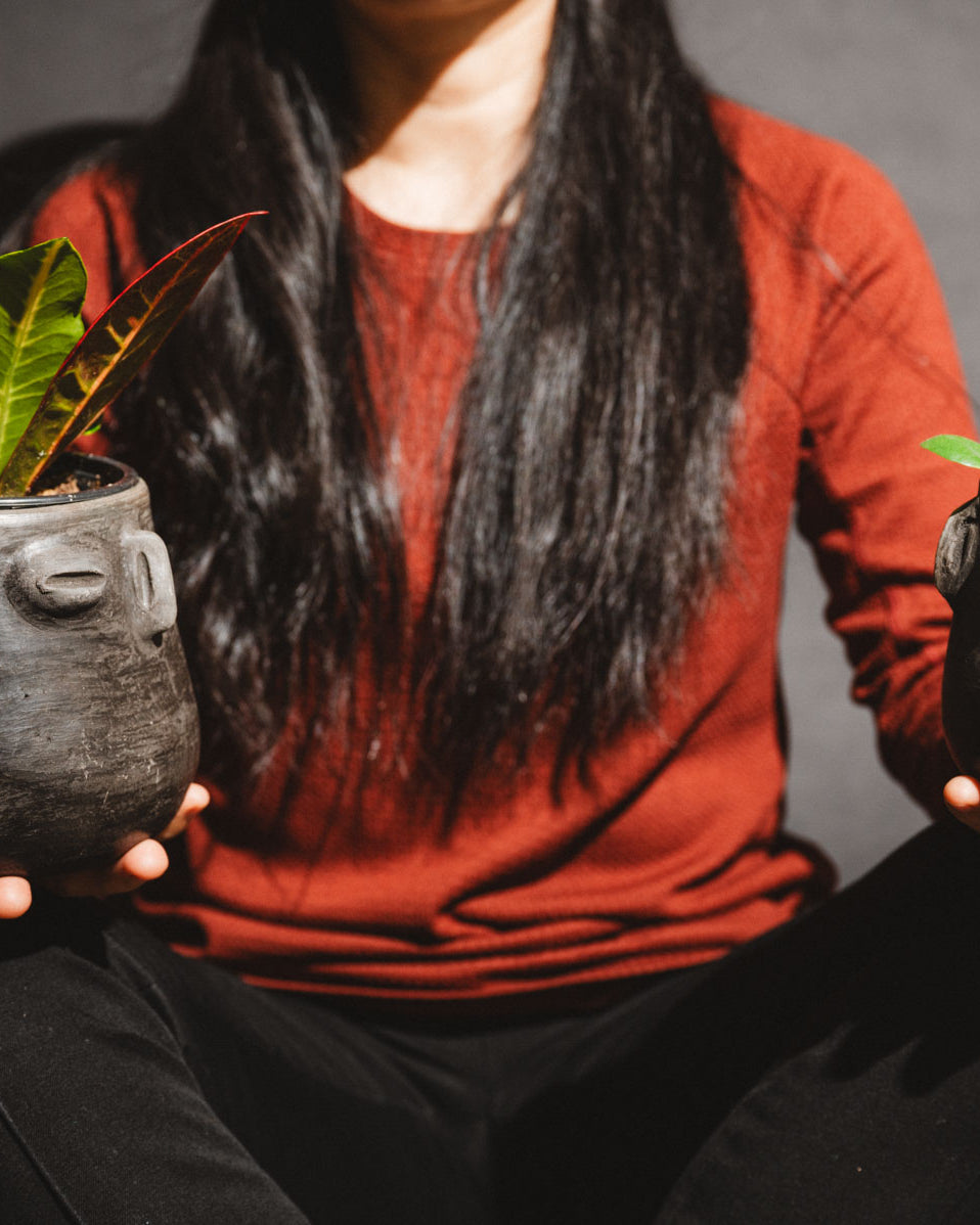 Woman holding handmade barro negro planters