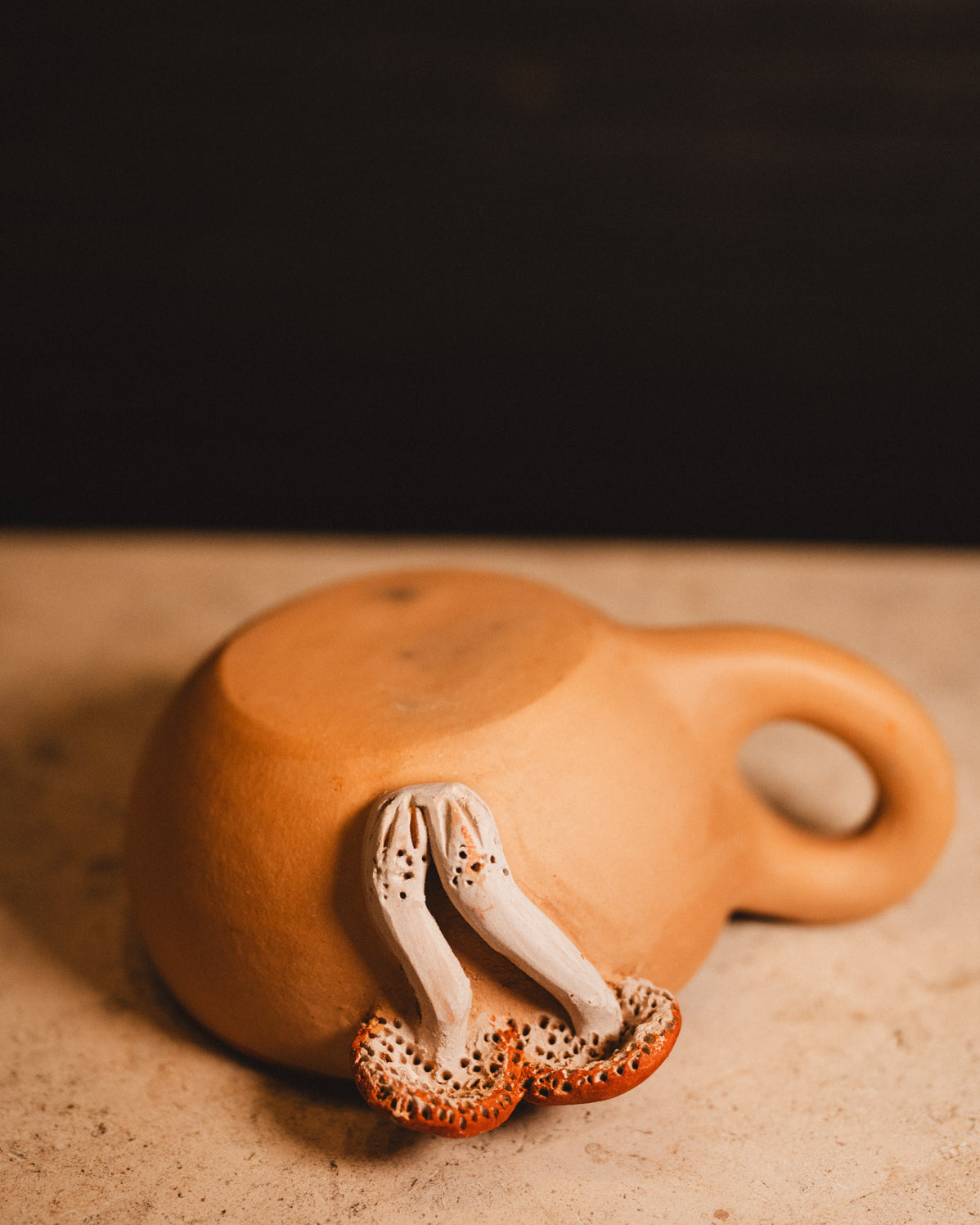 clay mushroom coffee mug on white counter