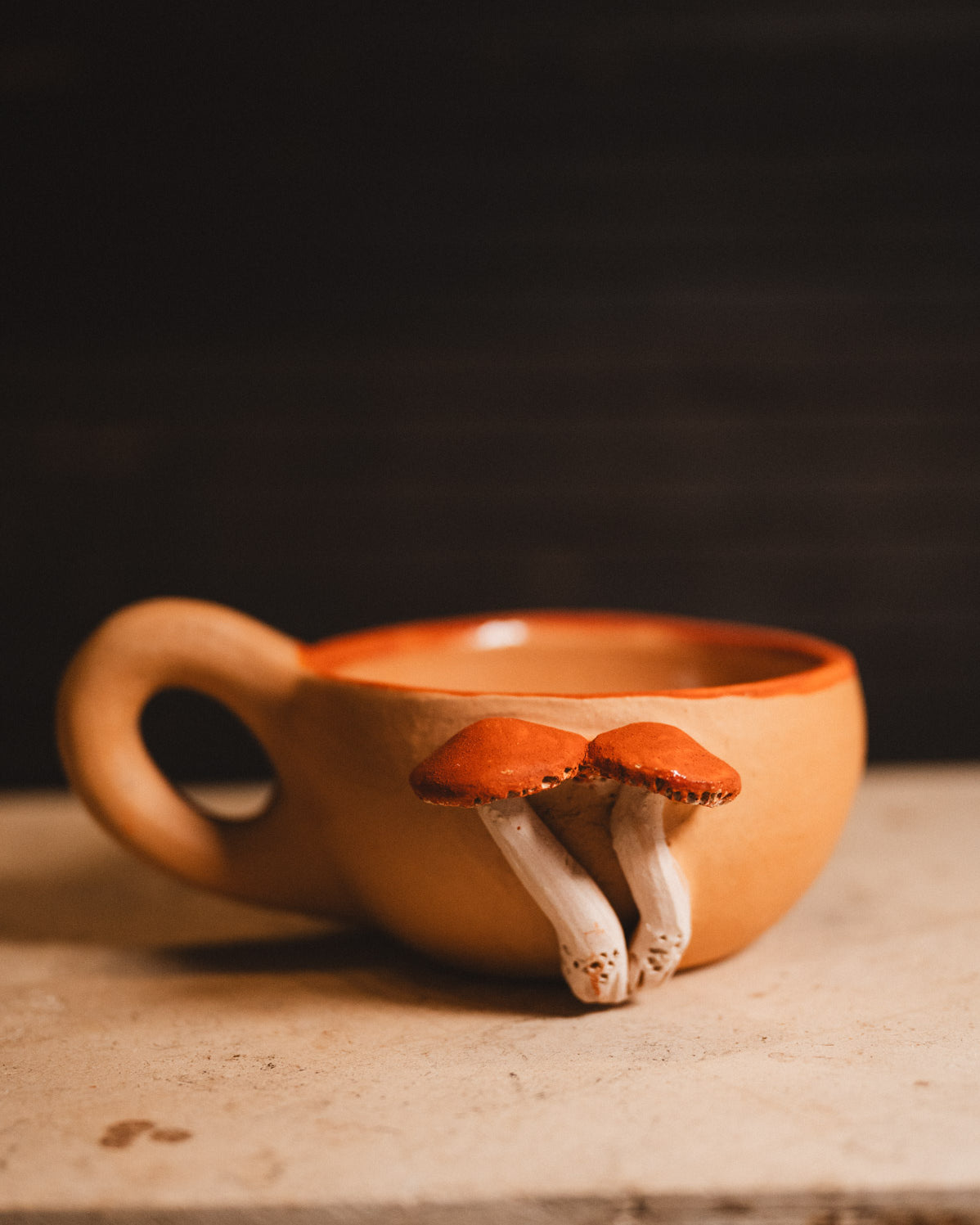 clay mushroom coffee mug on white counter