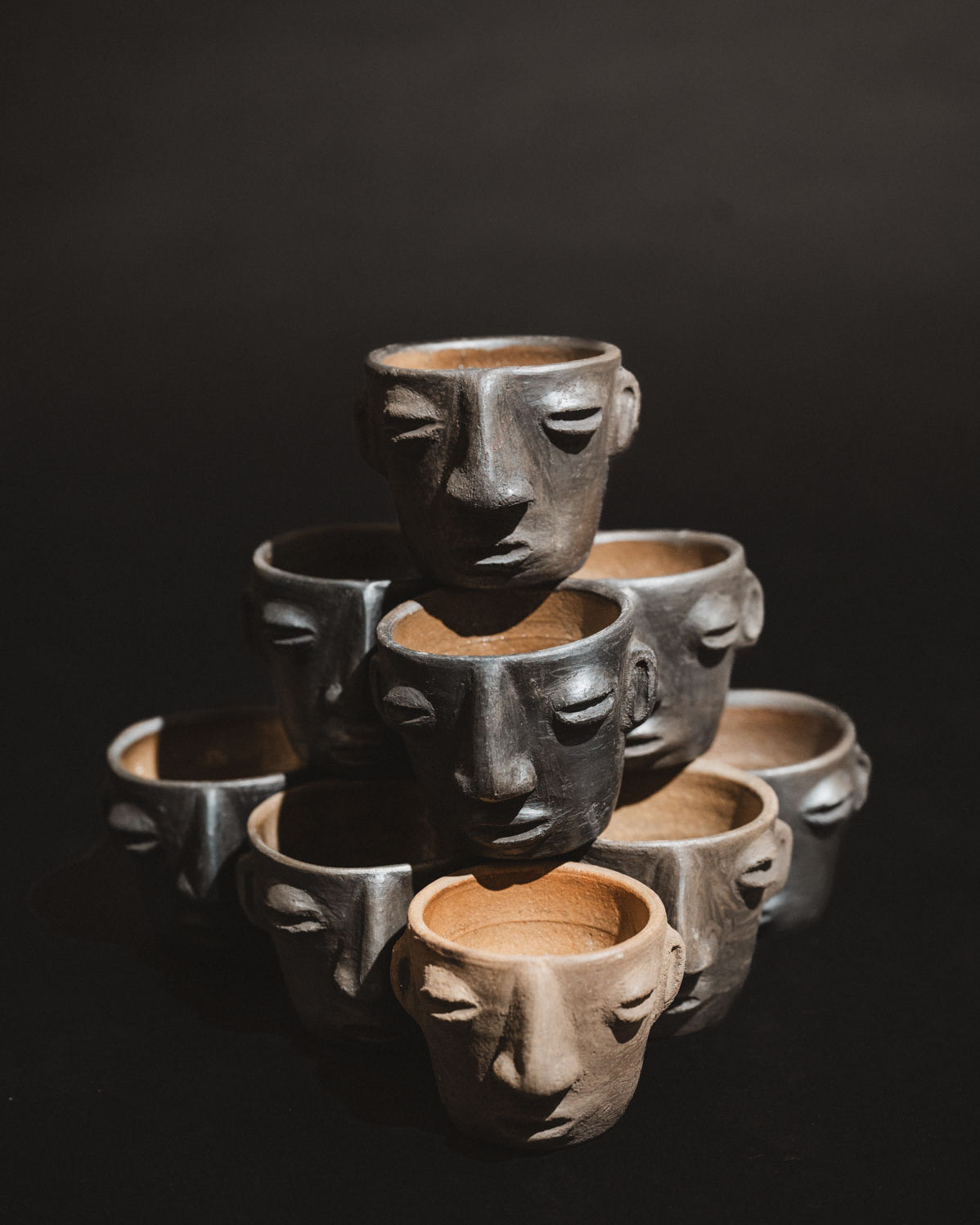 Handmade barro negro clay carita mezcalero cups from Oaxaca