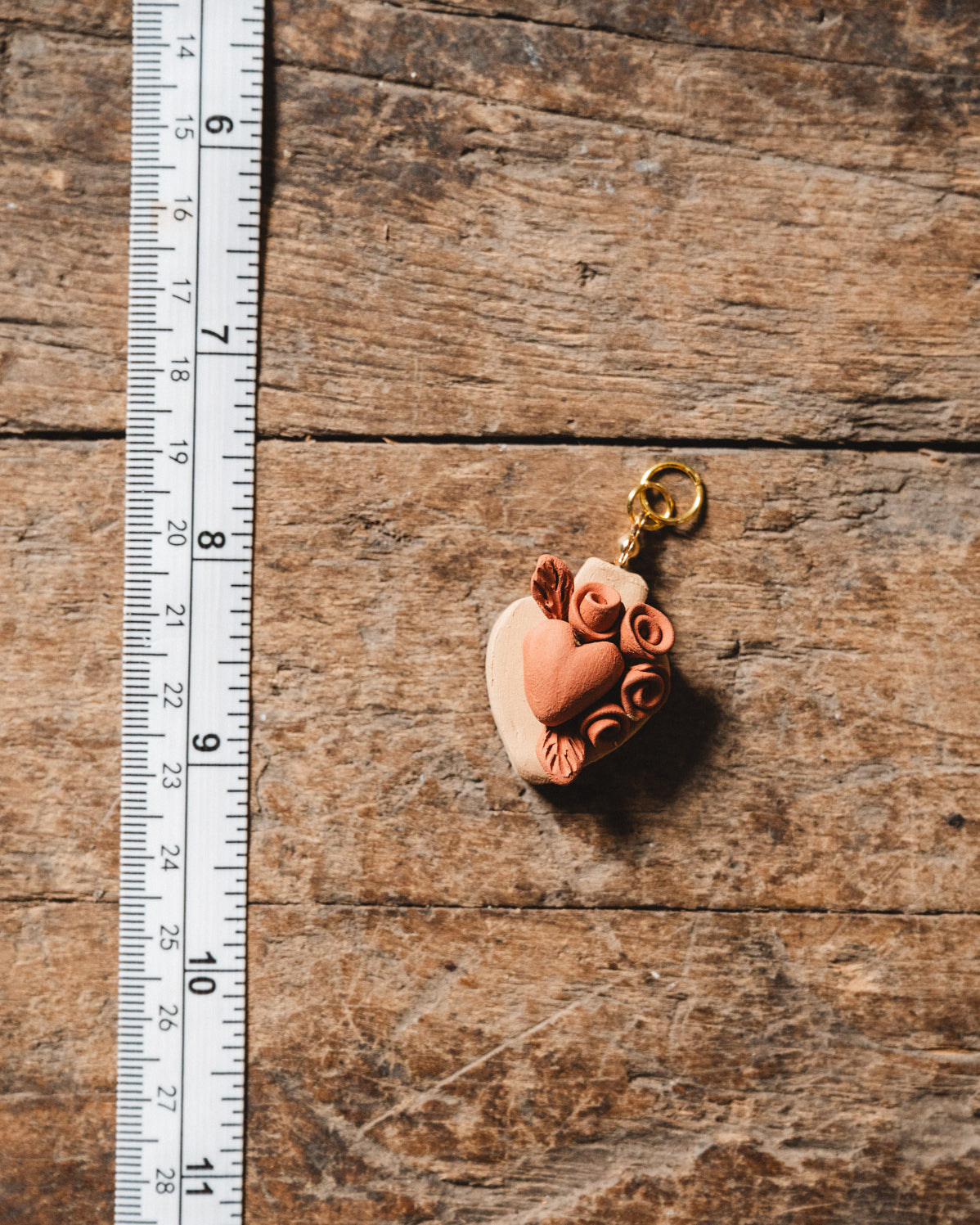 Small decorative item on a wooden surface with a ruler for scale.