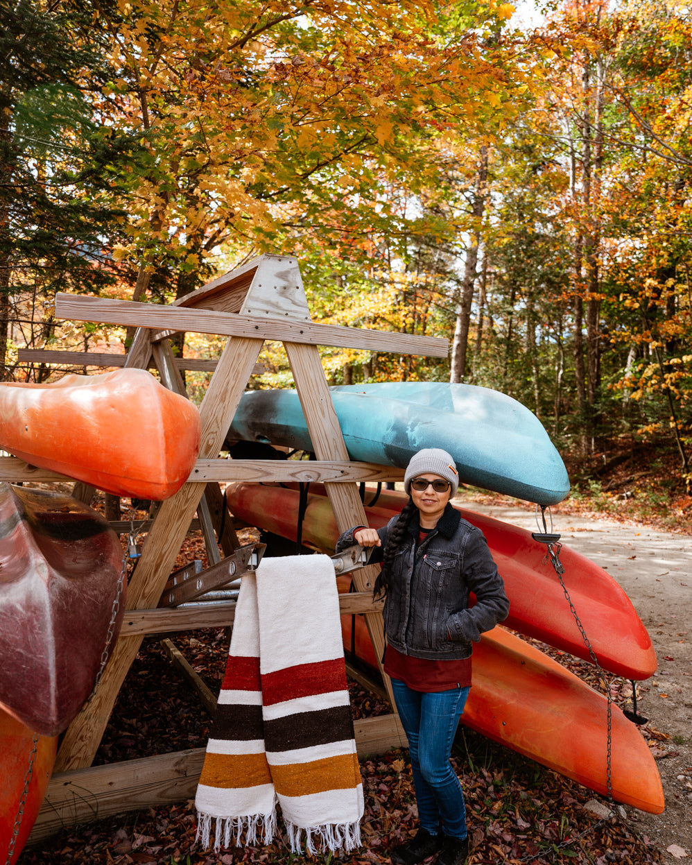 Girl standing in front of canoe rack