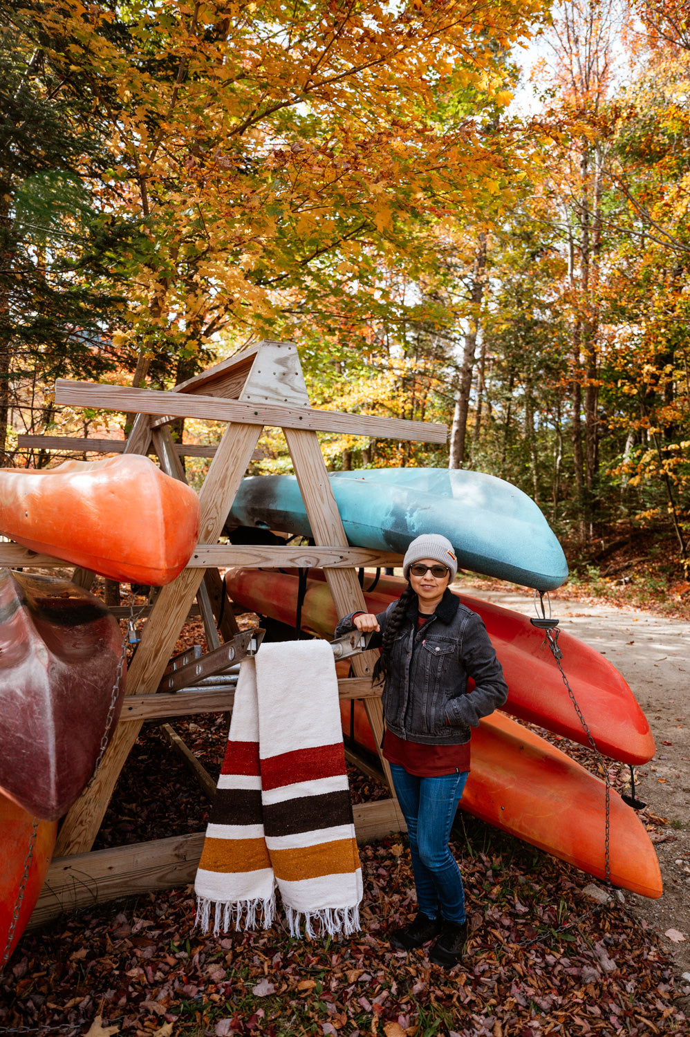 Girl standing in front of canoe rack