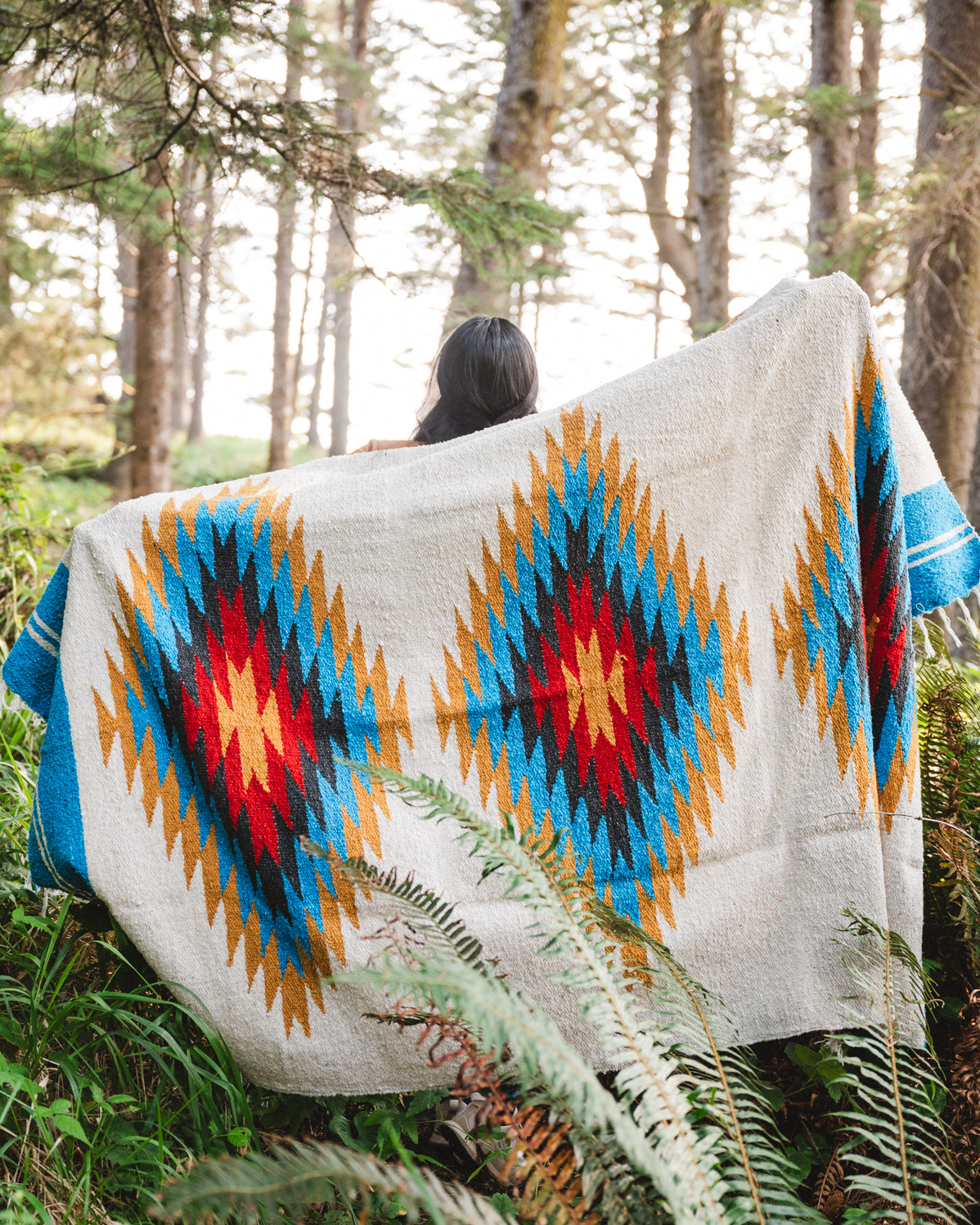 handwoven southwestern diamond sarape being worn by girl in forest