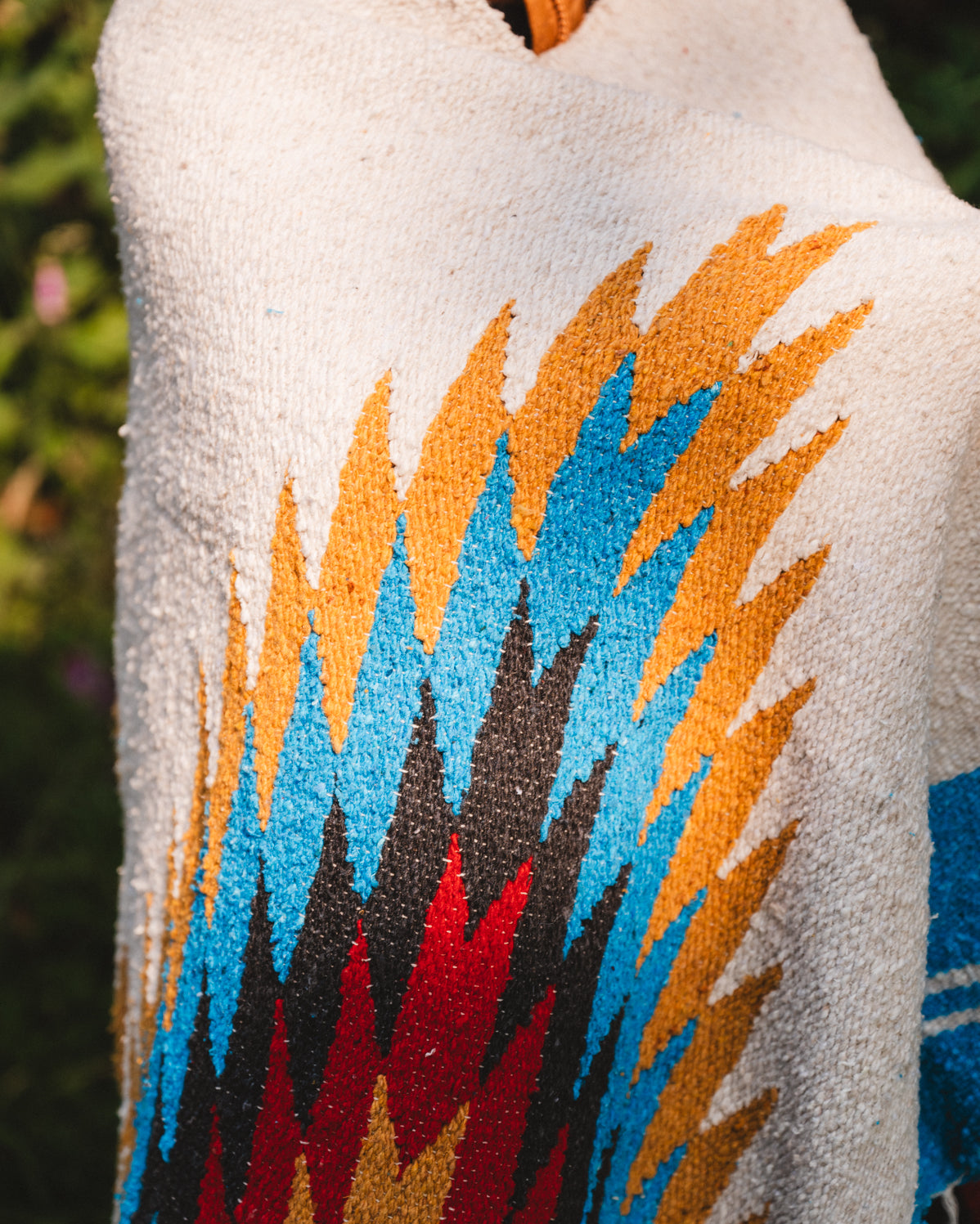 handwoven southwestern diamond sarape being worn by girl in forest