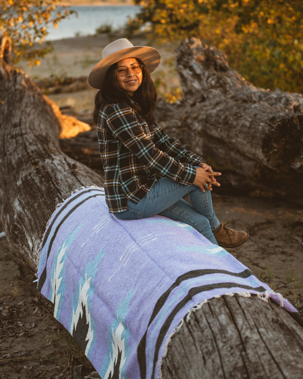 Girl sitting on handwoven lavender zapotec relampago mexican blanket
