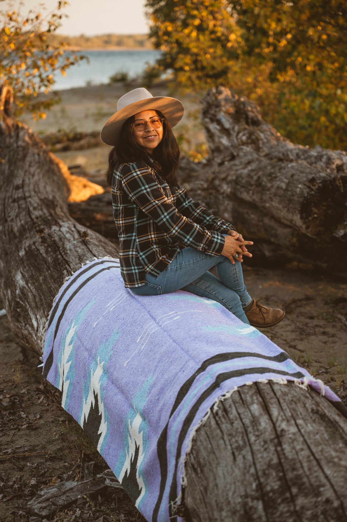 Girl sitting on handwoven lavender zapotec relampago mexican blanket