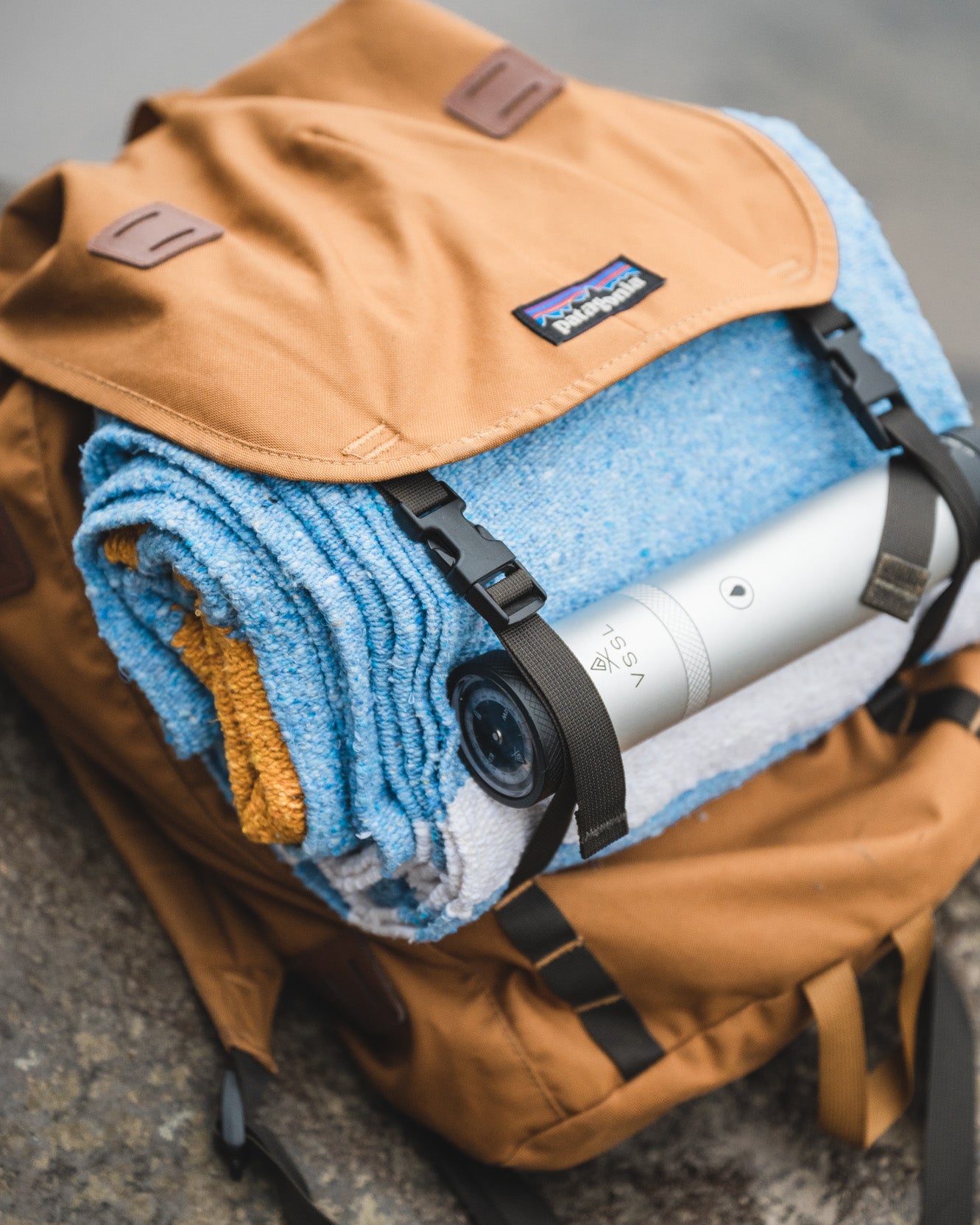 Patagonia backback filled with blue handwoven mexican blanket
