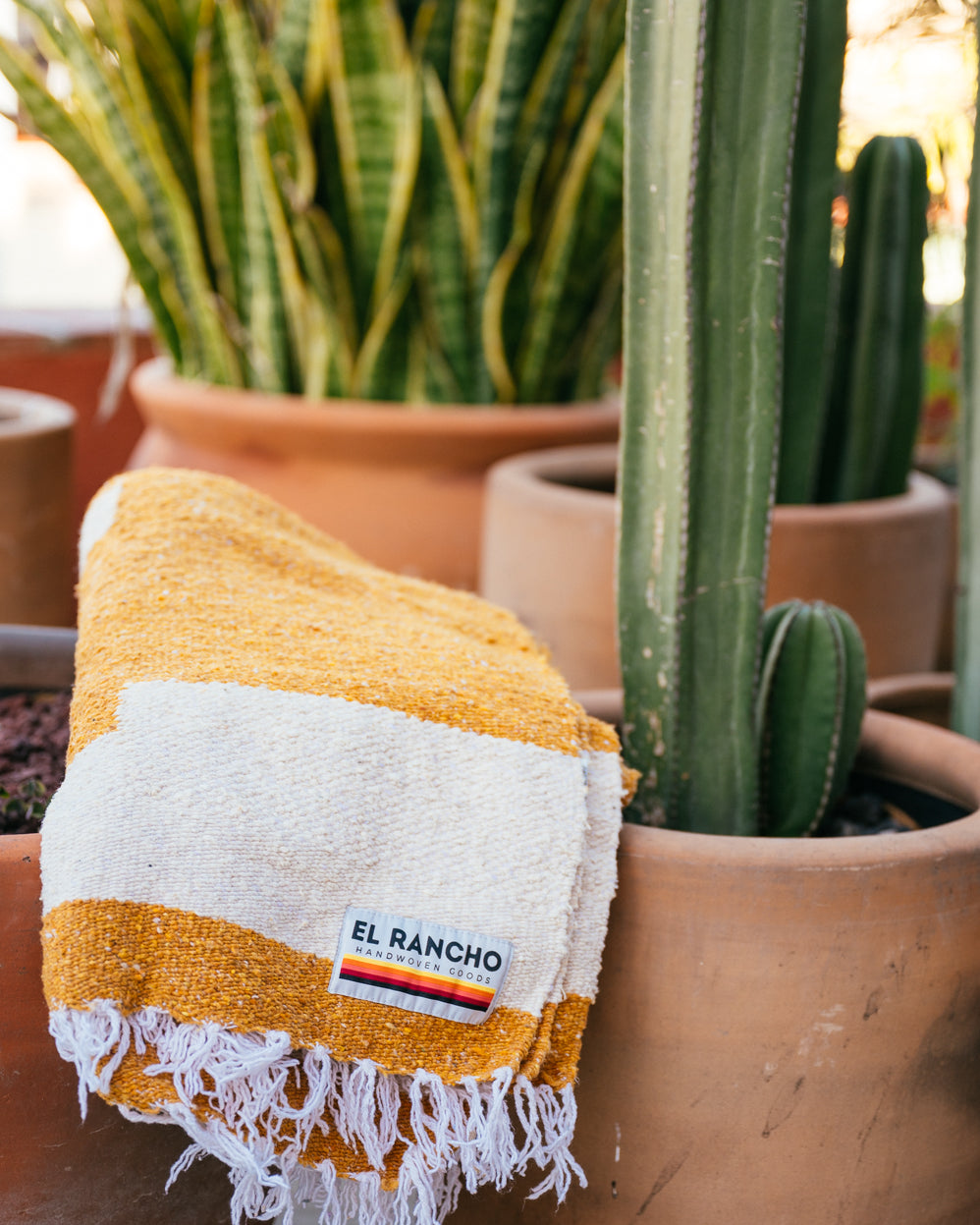 Folded blanket sitting on clay pots