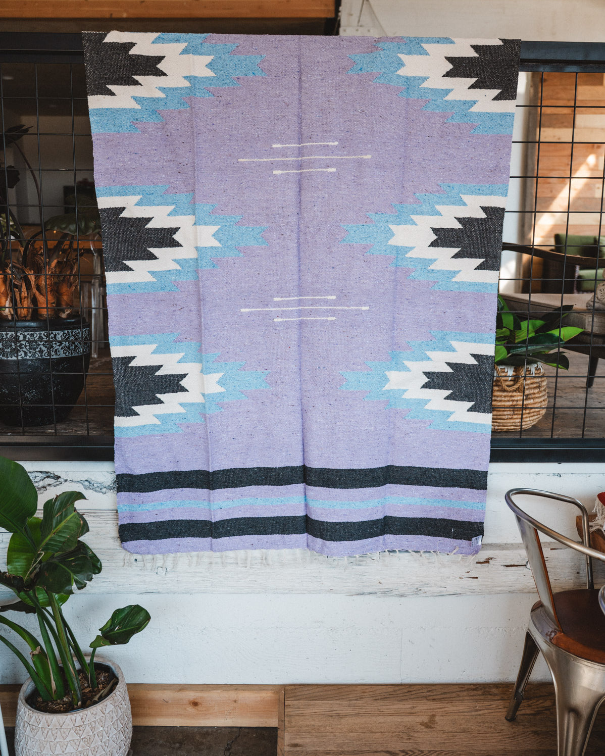 Handwoven Mexican Blanket Lavender Relampago pattern in modern industrial setting
