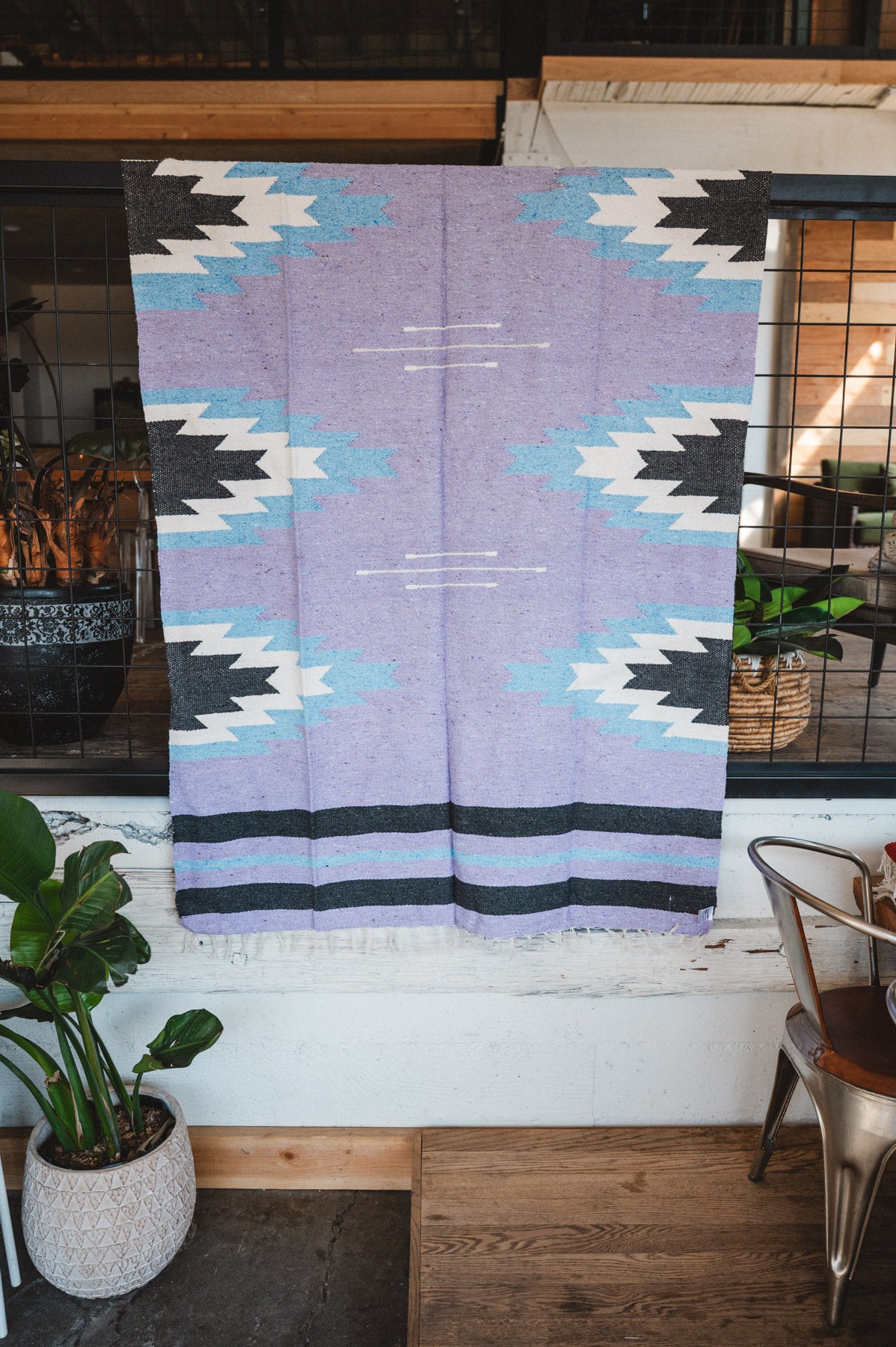 Handwoven Mexican Blanket Lavender Relampago pattern in modern industrial setting