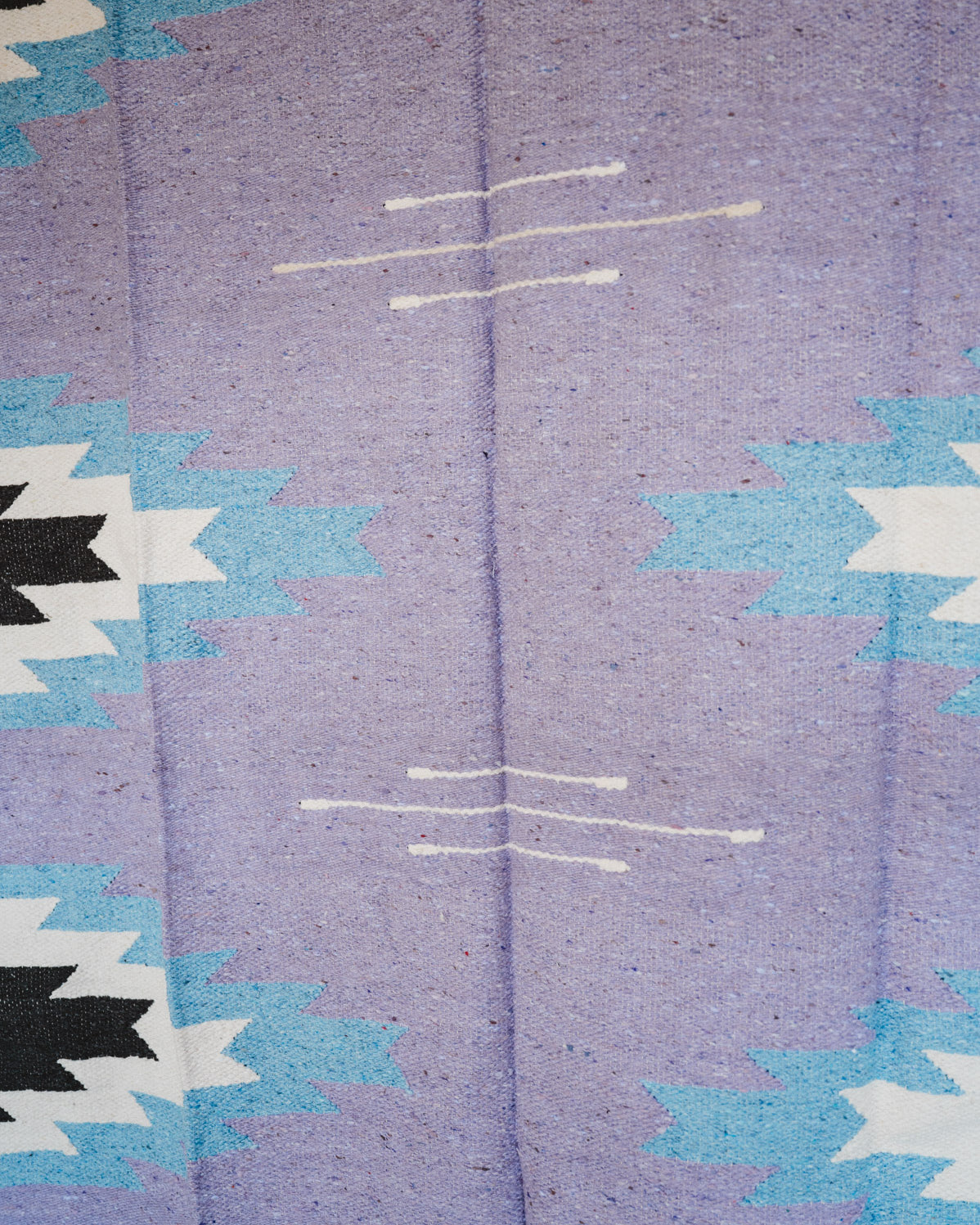 Handwoven Mexican Blanket Lavender Relampago pattern in modern industrial setting