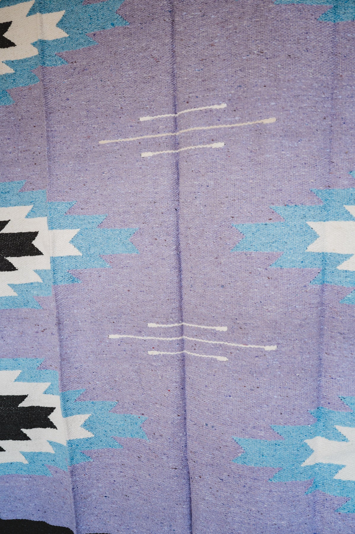 Handwoven Mexican Blanket Lavender Relampago pattern in modern industrial setting