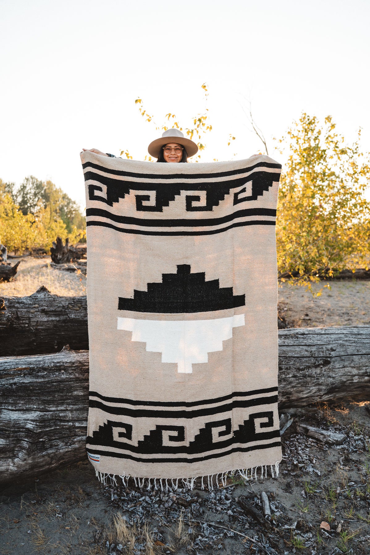 Greca Mixteca handwoven mexican blanket being held outside