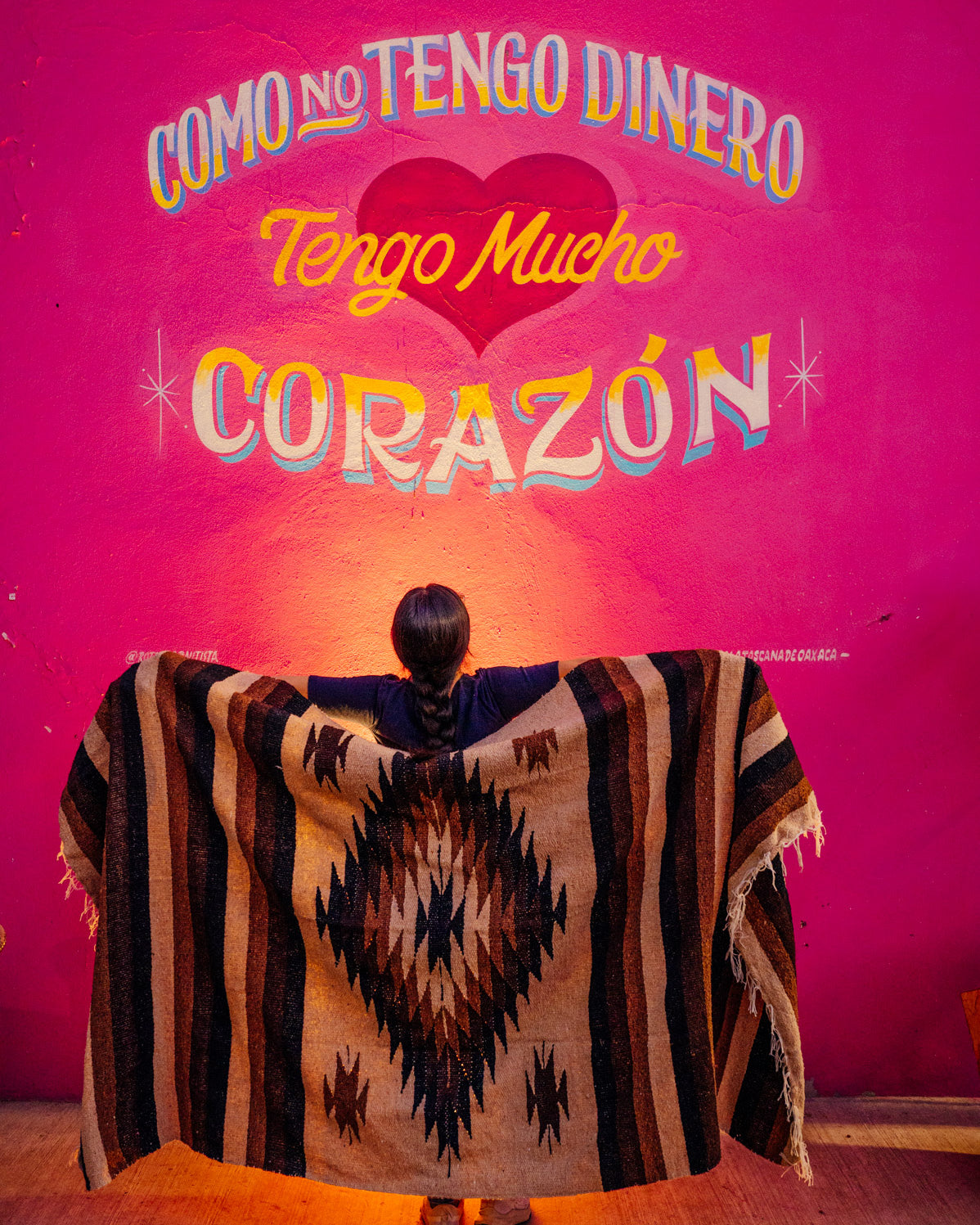 Brown mexican blanket against a pink wall