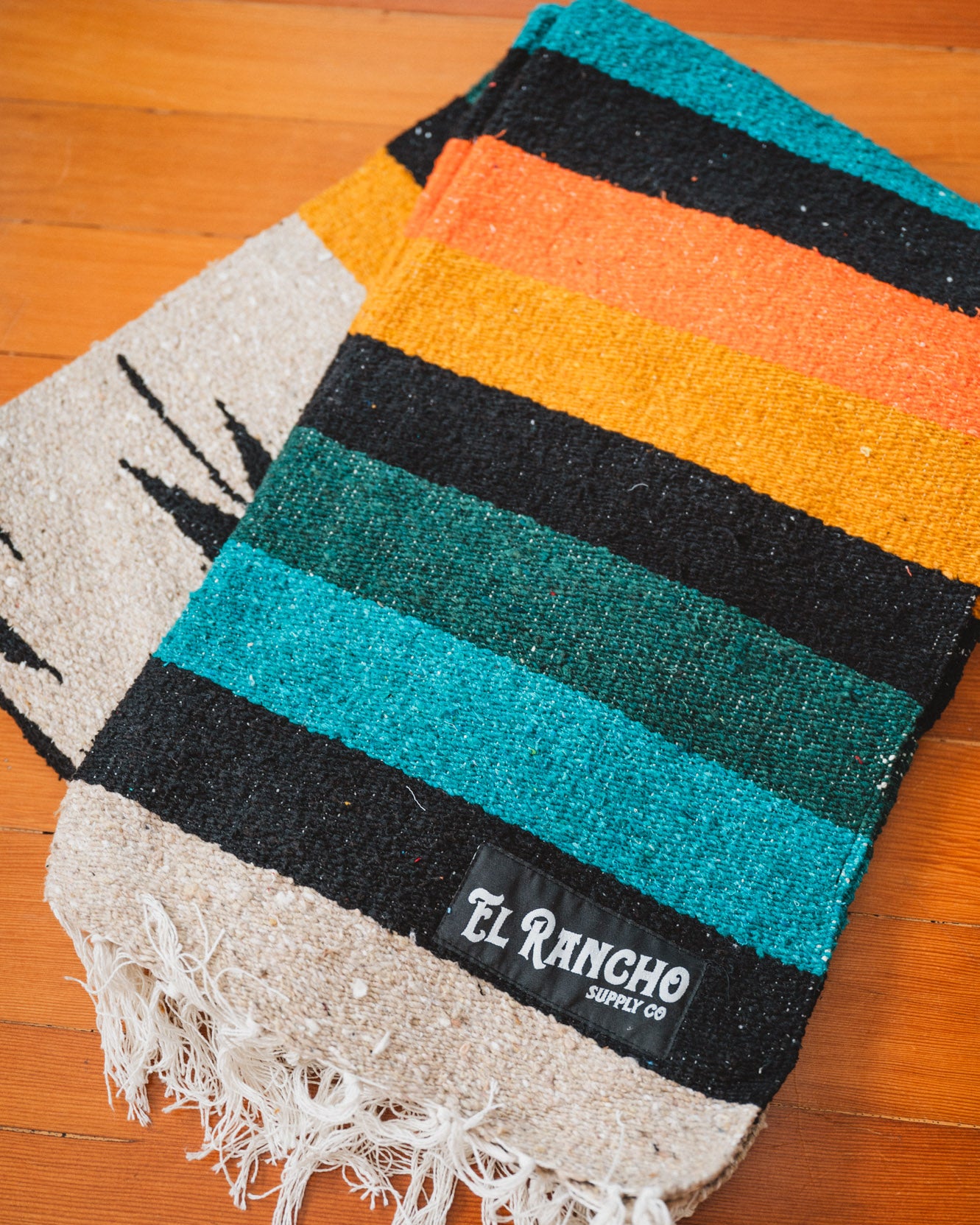 green and orange diamond blanket on the floor
