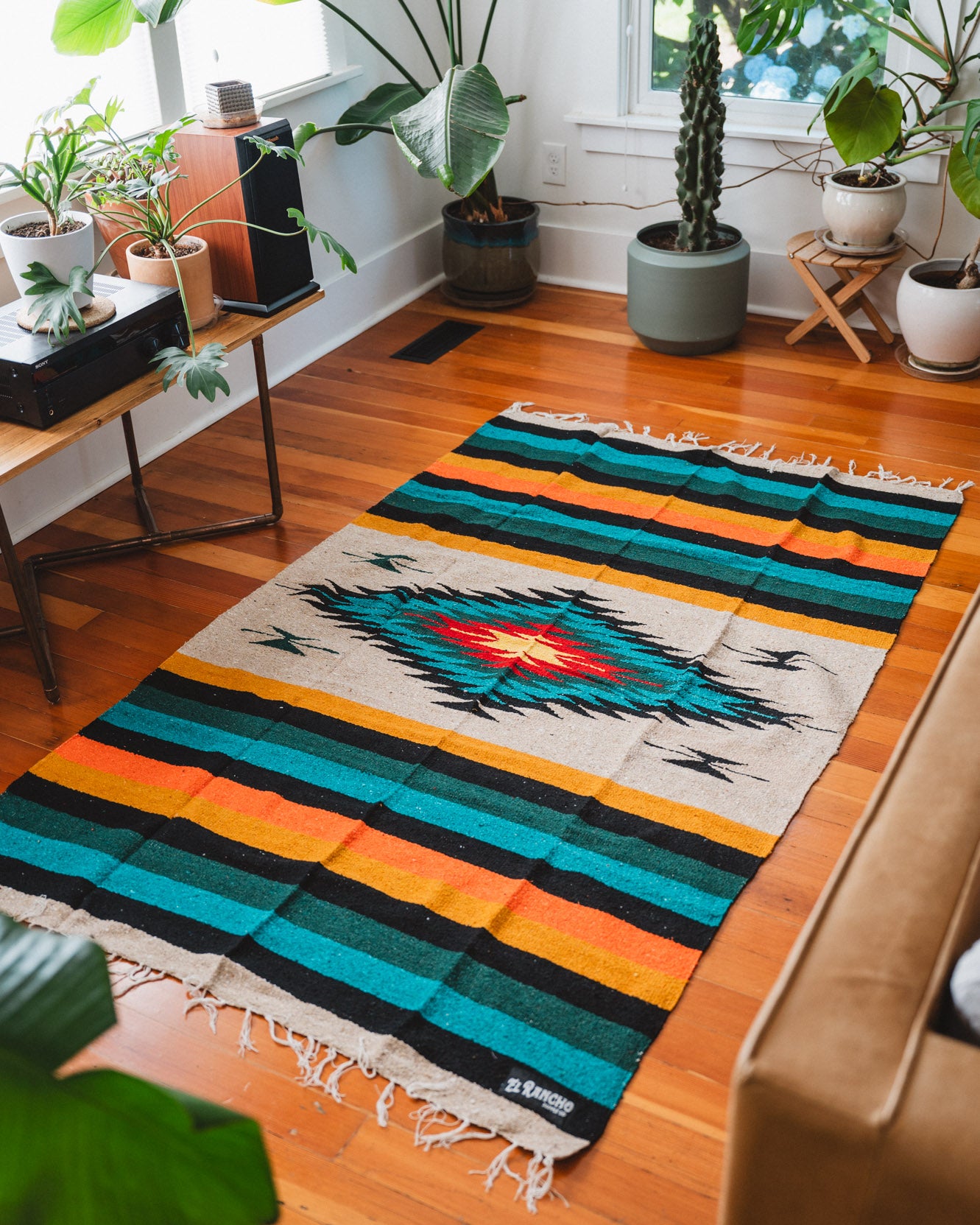 green and orange diamond blanket on the floor