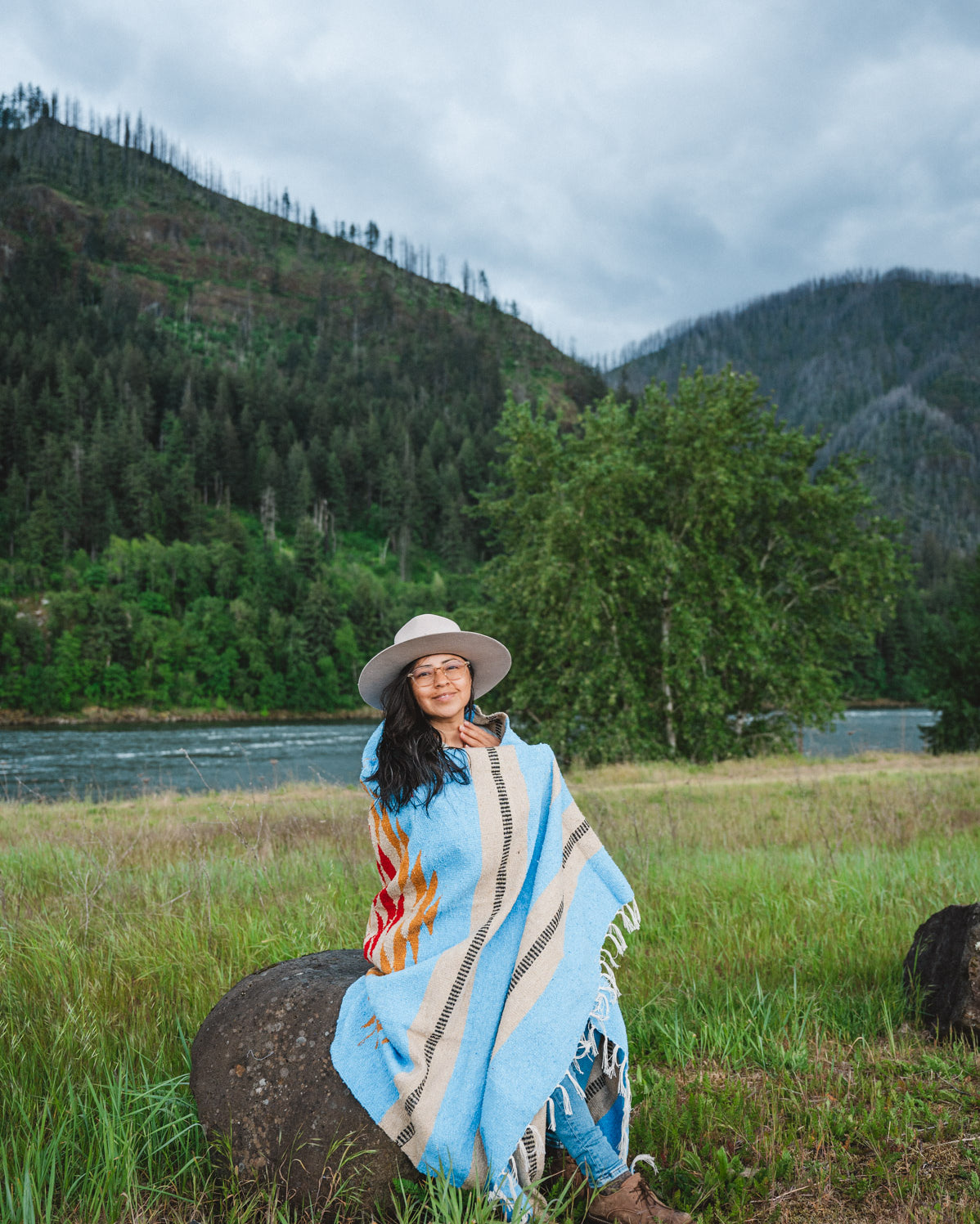 Mexican woman wrapped in blue handwoven mexican blanket