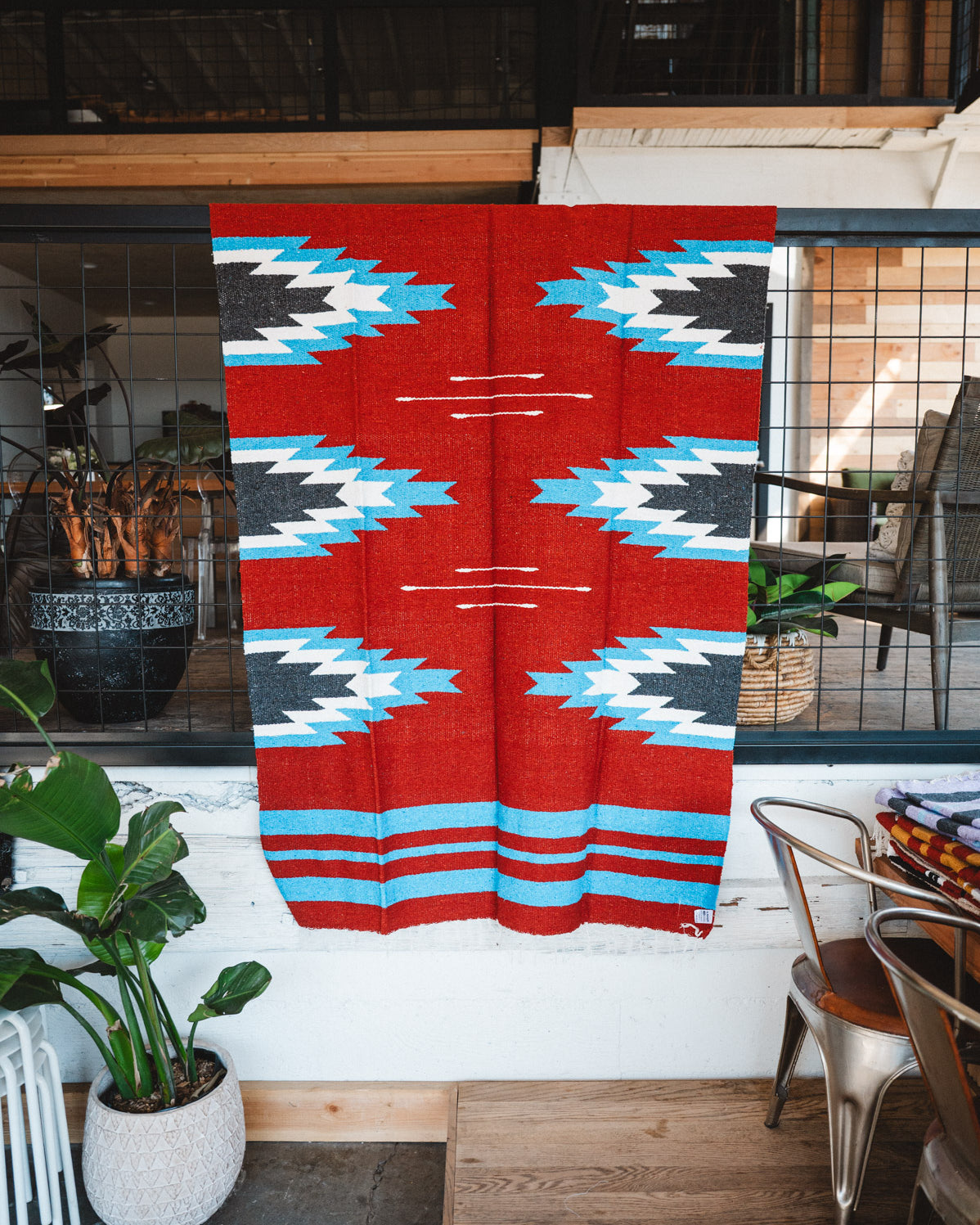 Handwoven Mexican Blanket Red, blue and black Relampago pattern in modern industrial setting