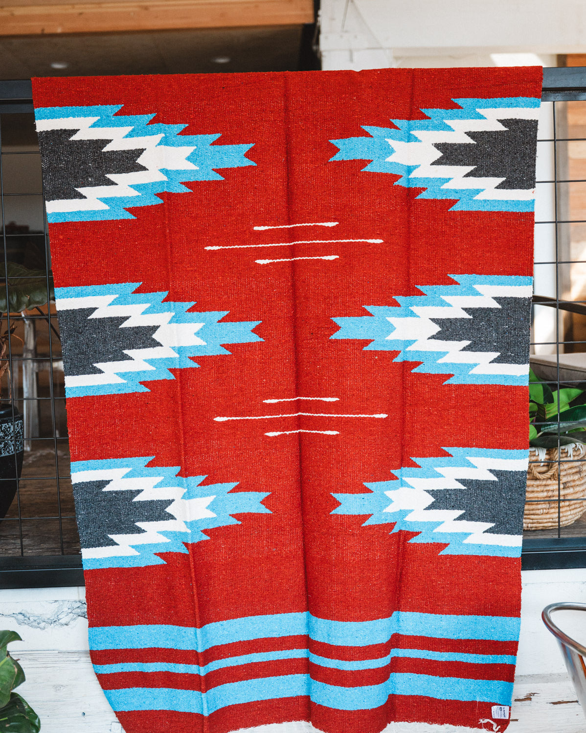 Handwoven Mexican Blanket Red, blue and black Relampago pattern in modern industrial setting
