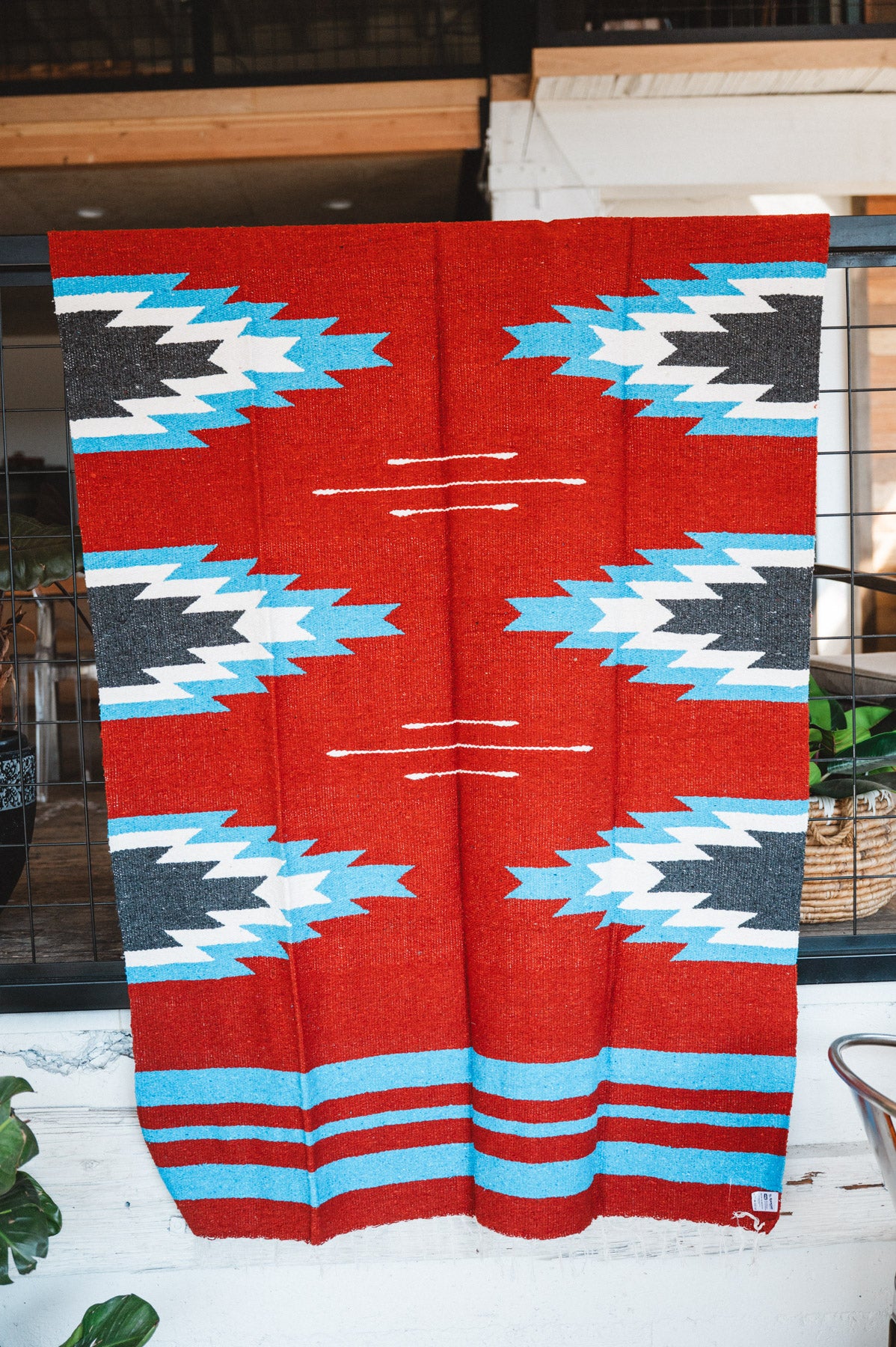Handwoven Mexican Blanket Red, blue and black Relampago pattern in modern industrial setting