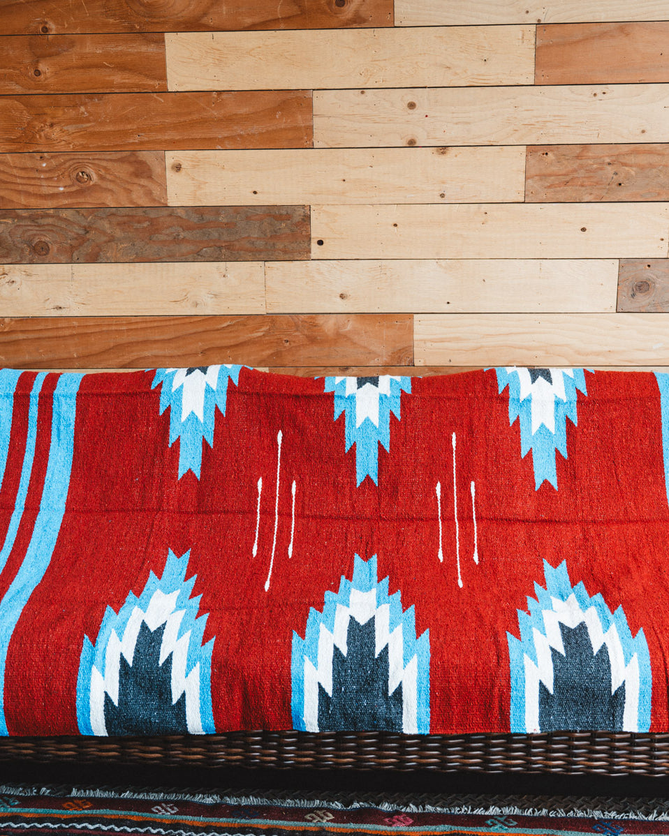 Handwoven Mexican Blanket Red, blue and black Relampago pattern in modern industrial setting