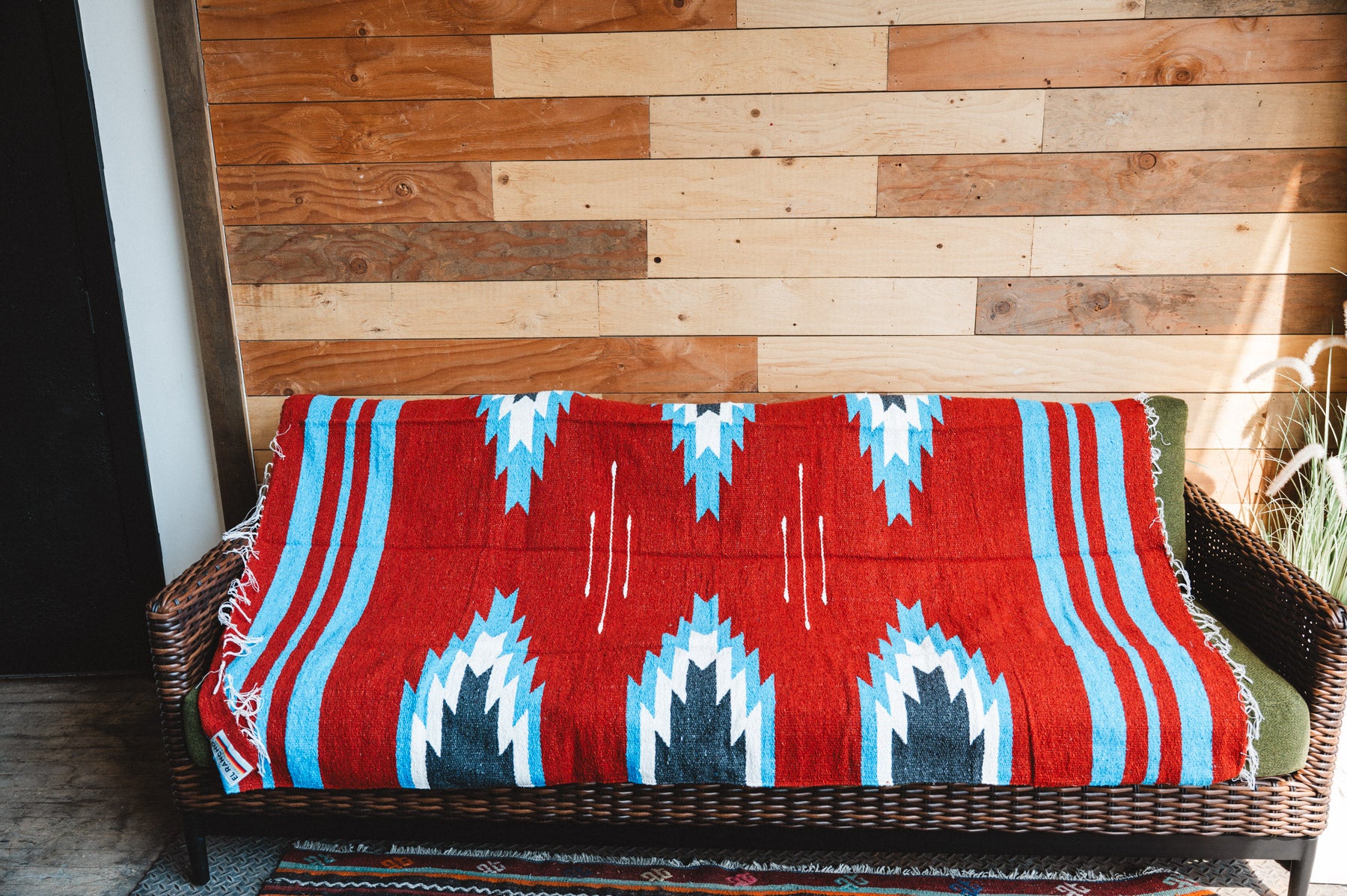 Handwoven Mexican Blanket Red, blue and black Relampago pattern in modern industrial setting