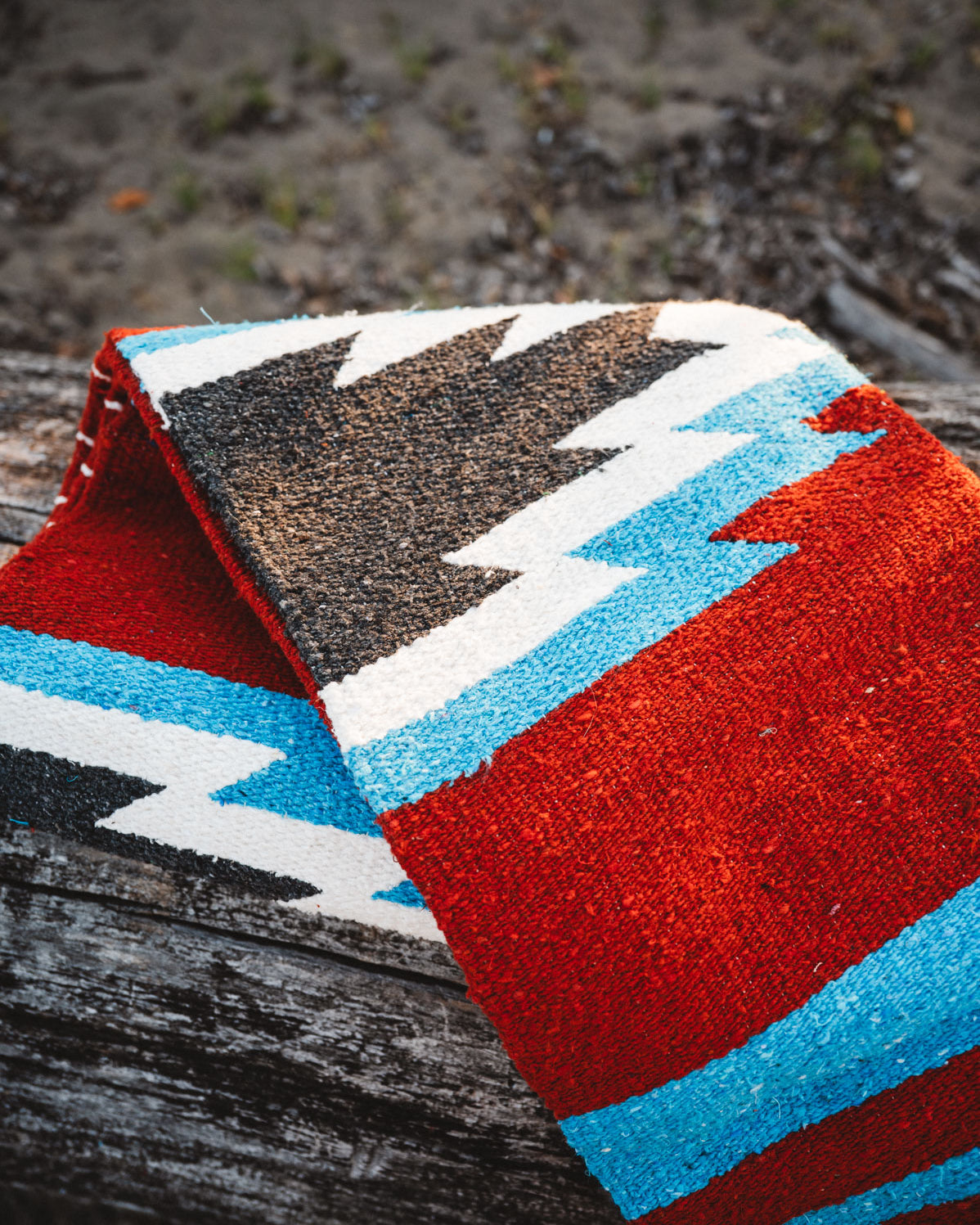 Colorful patterned rug with geometric design on a wooden surface