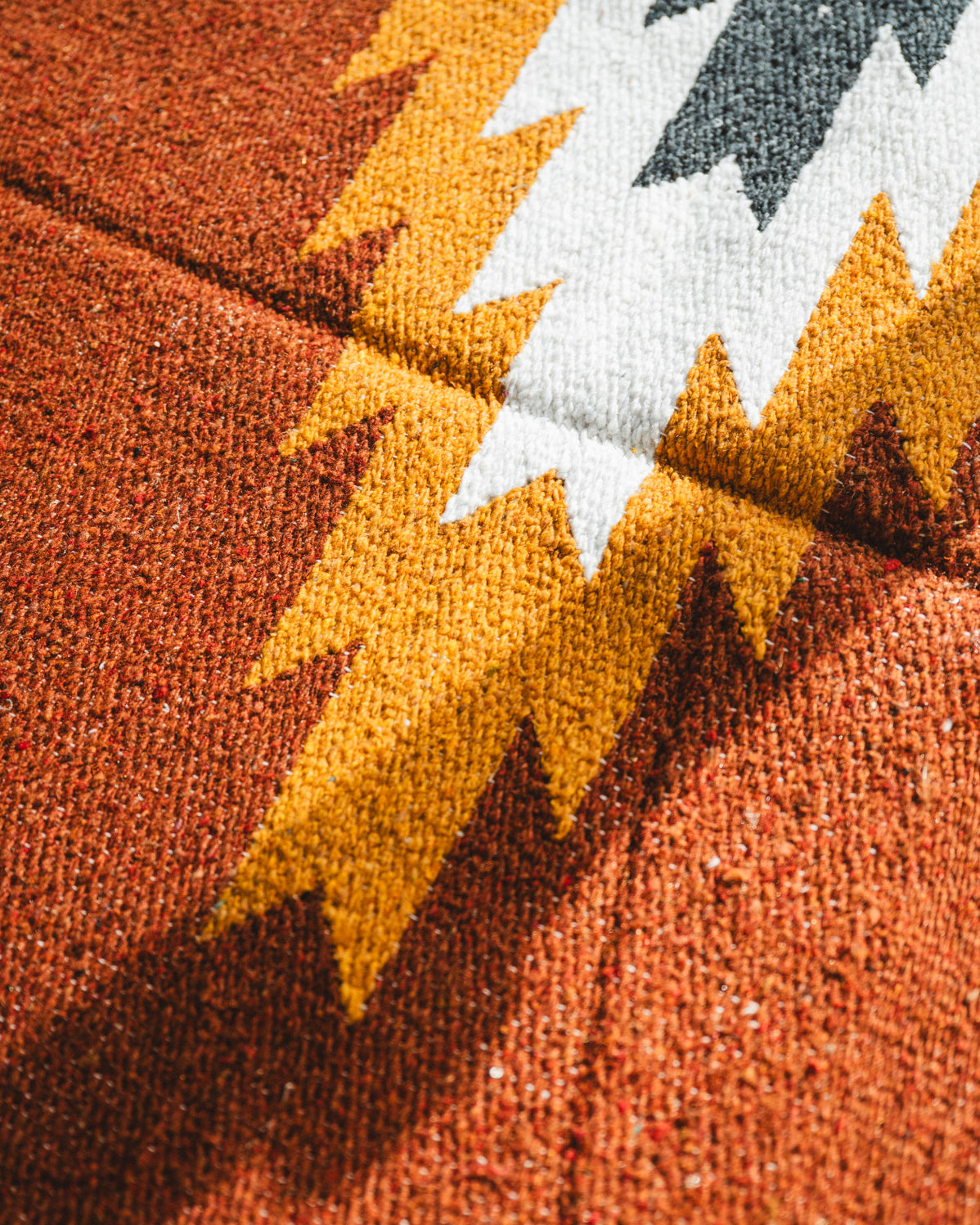 Close-up of a textured fabric with autumn leaf pattern