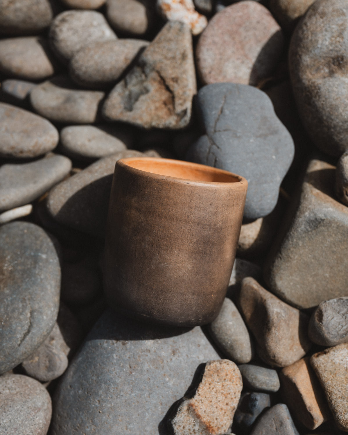 Rustic oaxacan barro negro coffee cup on rocks