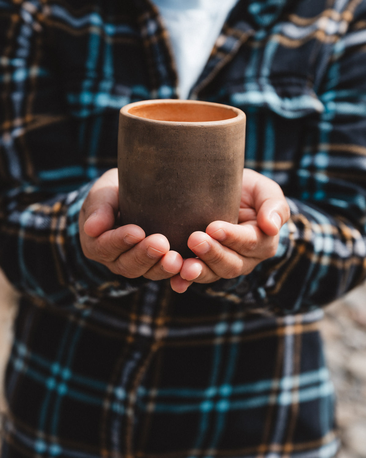 rustic oaxacan barro negro coffee cup held in hands