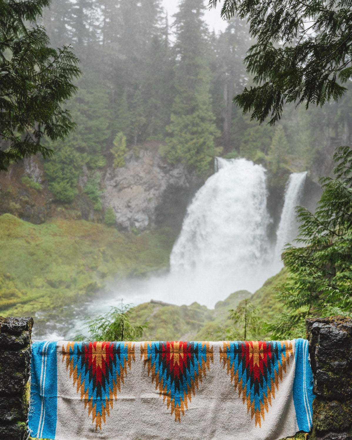 Handwoven Mexican Blanket in front of Sahalie Falls Oregon in the Mckenzie River Corridor