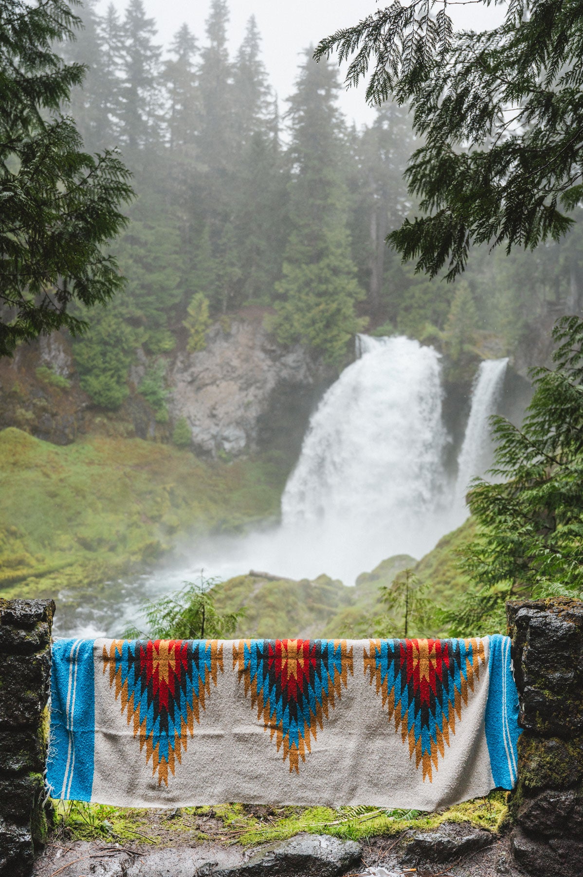 Handwoven Mexican Blanket in front of Sahalie Falls Oregon in the Mckenzie River Corridor
