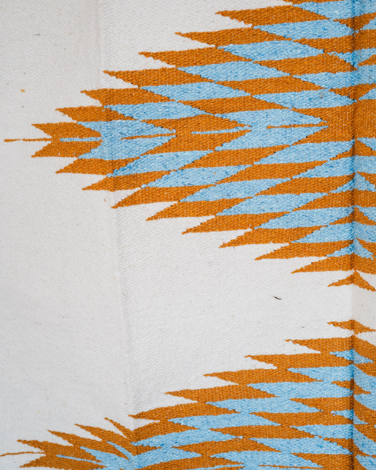 Handwoven Mexican Blanket Turquoise and gold color 3 Diamond pattern in modern industrial setting