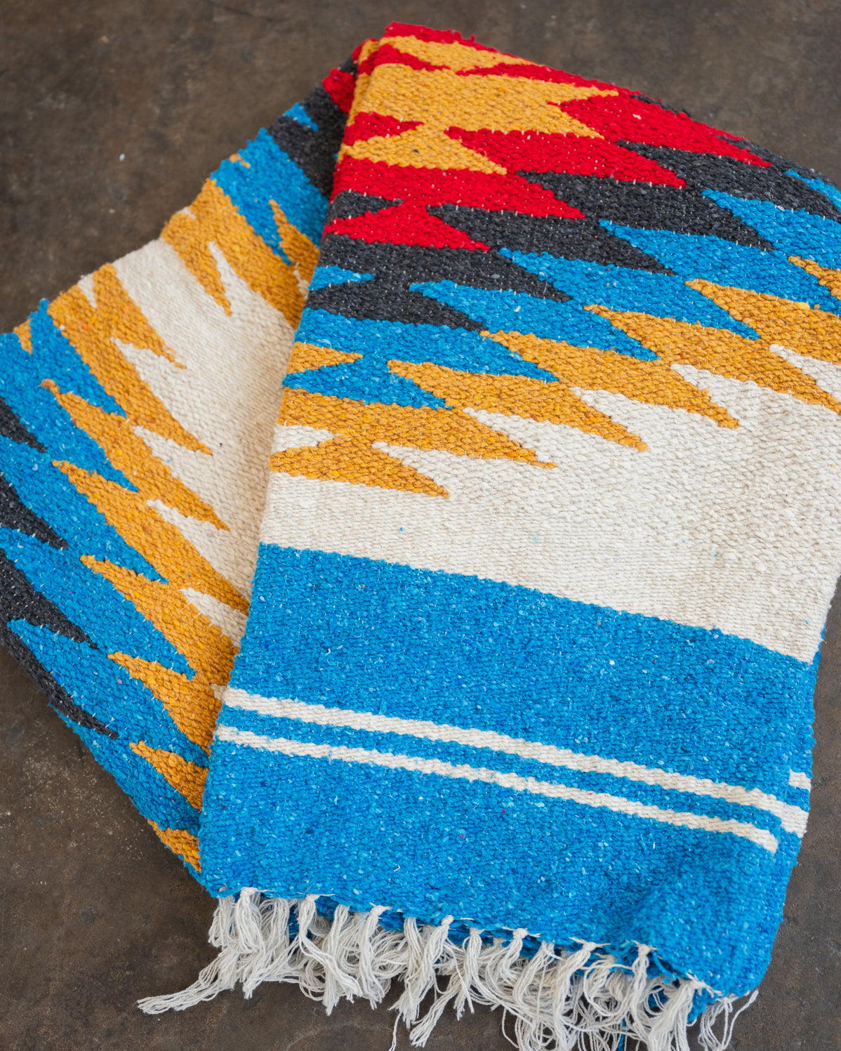 Red and yellow and blue southwestern diamond handwoven blanket folded